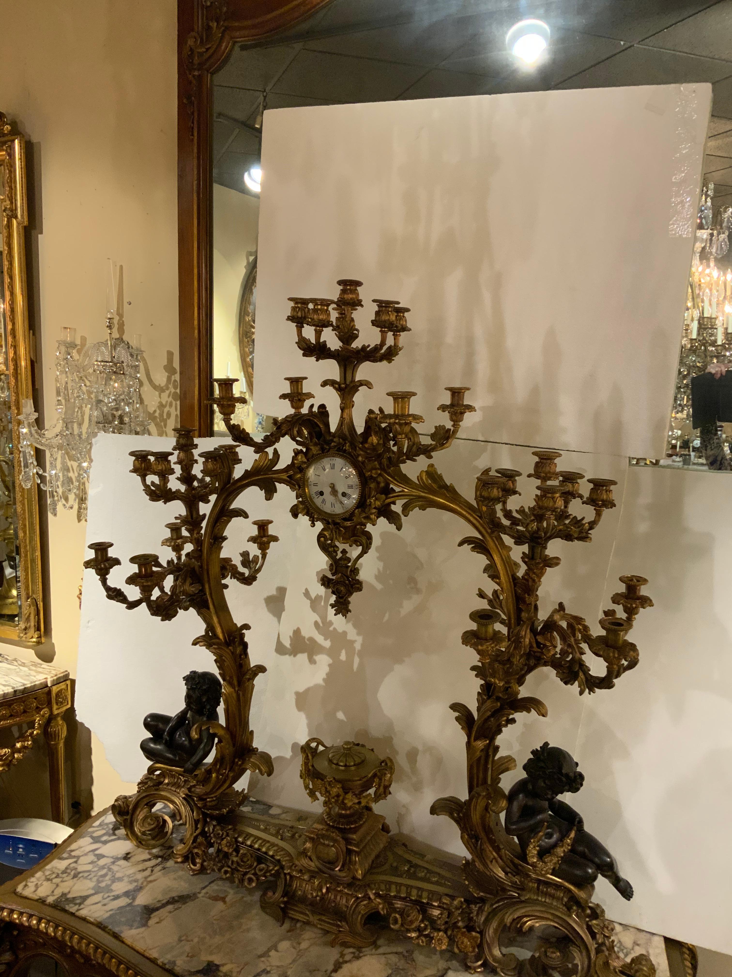 Gilt Bronze Doré and Patinated  French Clock with 26 Candelabrum with putti In Good Condition In Houston, TX