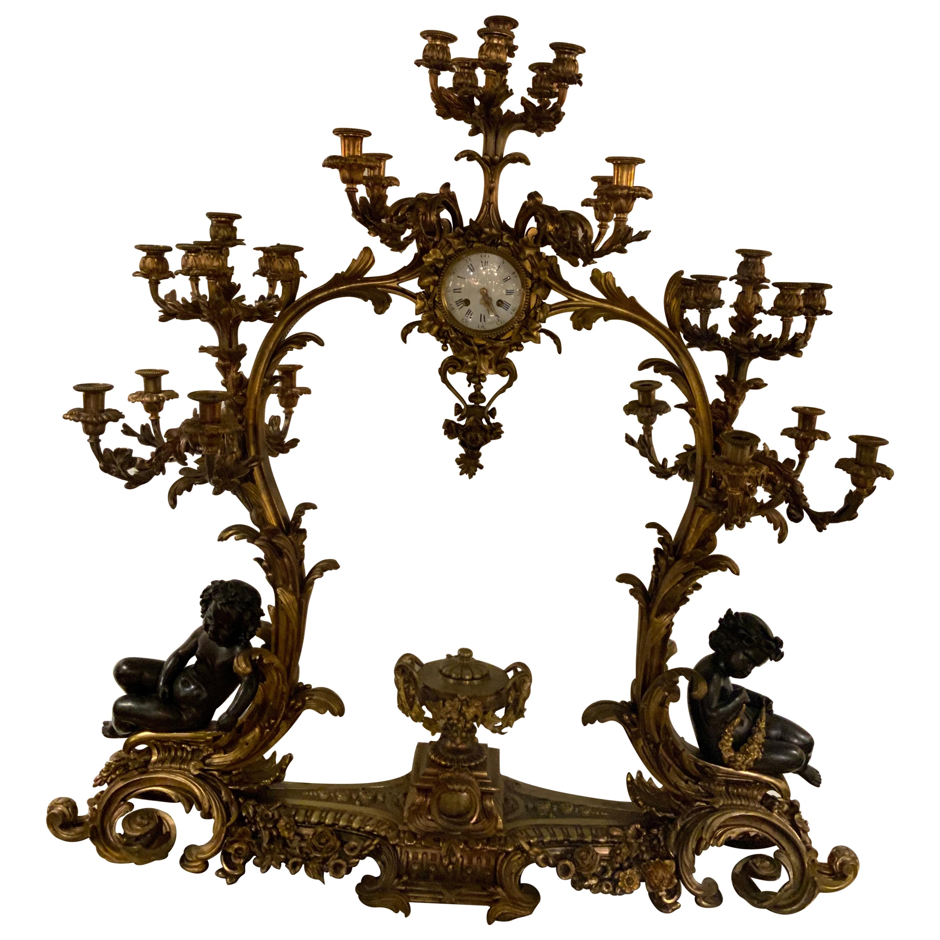 Gilt Bronze Doré and Patinated  French Clock with 26 Candelabrum with putti