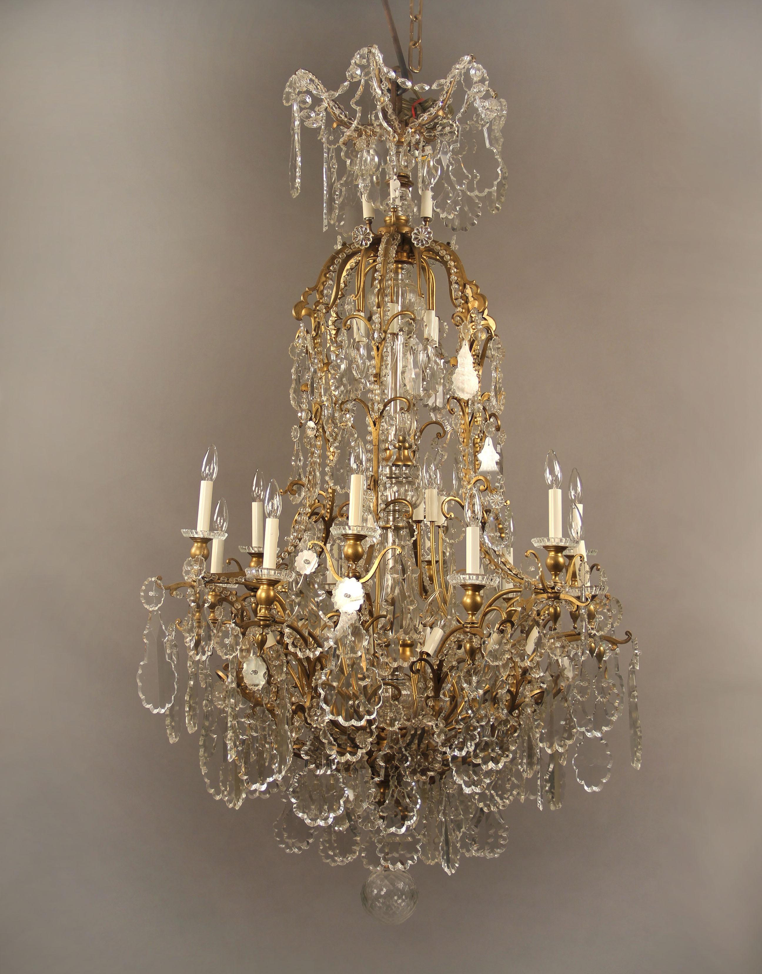 A palatial and rare late 19th century gilt bronze and baccarat crystal thirty-nine-light chandelier.

Multifaceted and shaped crystal, beaded arms with crystal swags, cut crystal central column, twelve perimeter and twenty-seven-tiered interior