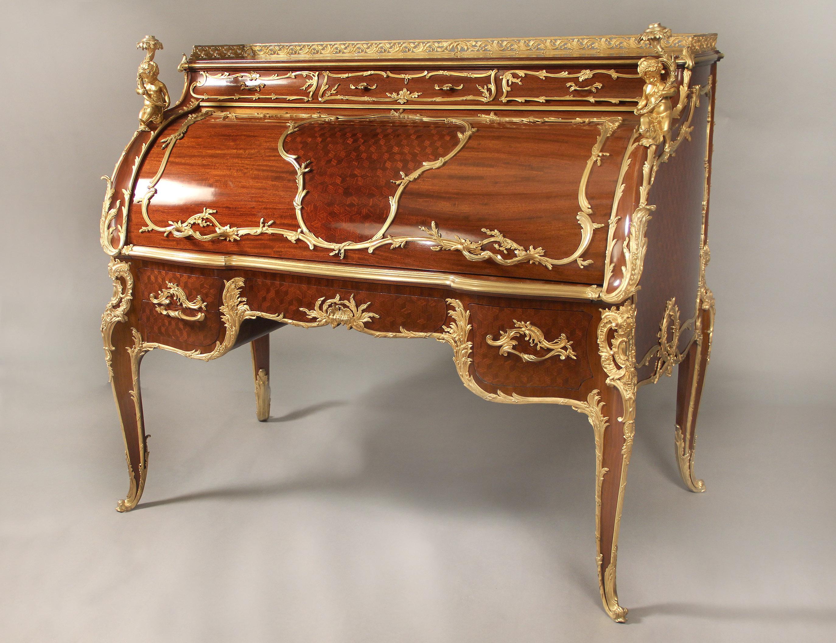 A very special and Palatial early 20th century Louis XV style gilt bronze mounted Mahogany and Bois Satine Parquetry Bureau a Cylindre by François Linke

François Linke – Index Number 242

Surmounted by a pierced guilloche acanthus gallery above
