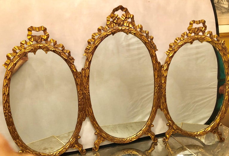Palatial French Giltwood Triple Oval Shaped Vanity Mirror with Carved