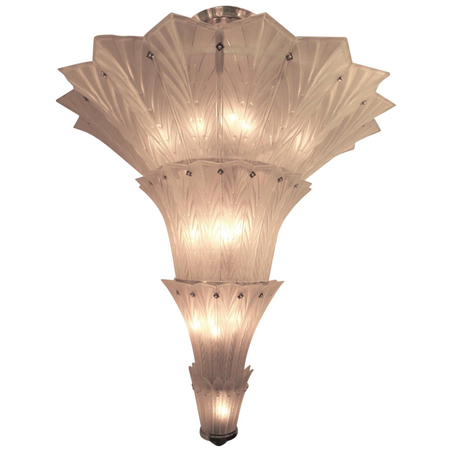 A magnificent and huge multi-tiered frosted art glass chandelier by Sabino.
Four glass tiers reminiscent of a waterfall or palm tree cascade down the very large frame tapering gently and culminating in a nickelled finial. Hung by four fluted