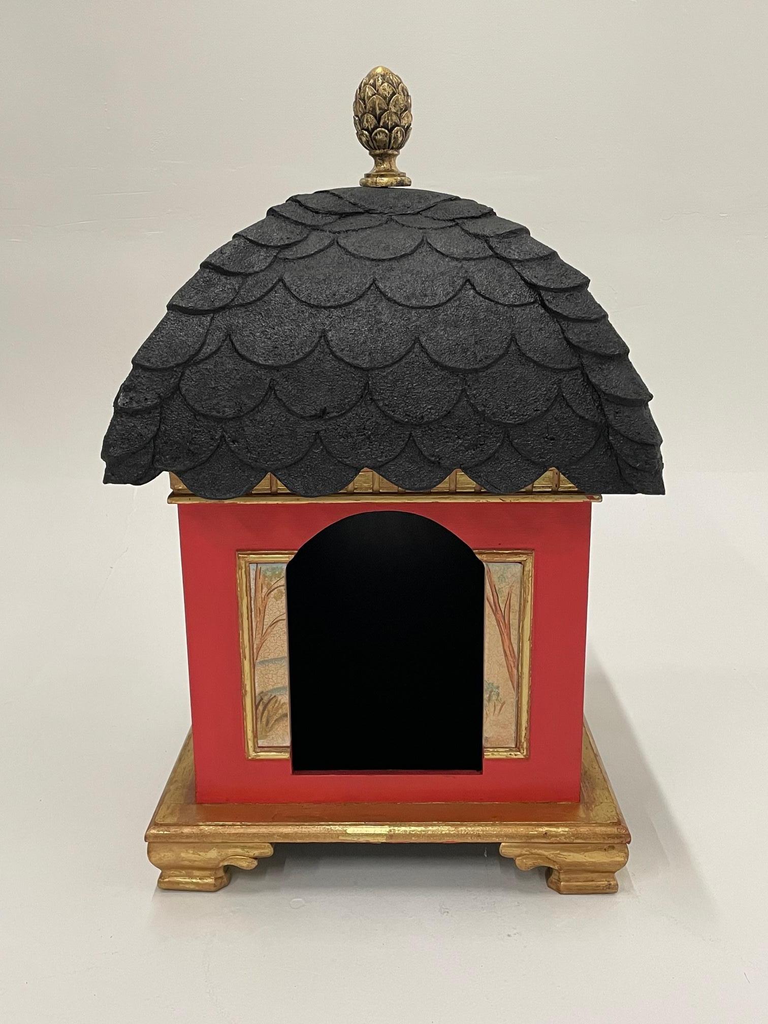 For the dog who has everything, an over the top Hollywood Regency style doghouse in red, black and gold. Lovely pastural scenes are painted on the sides.
Opening for lucky puppy; 13 H x 9 W.
 