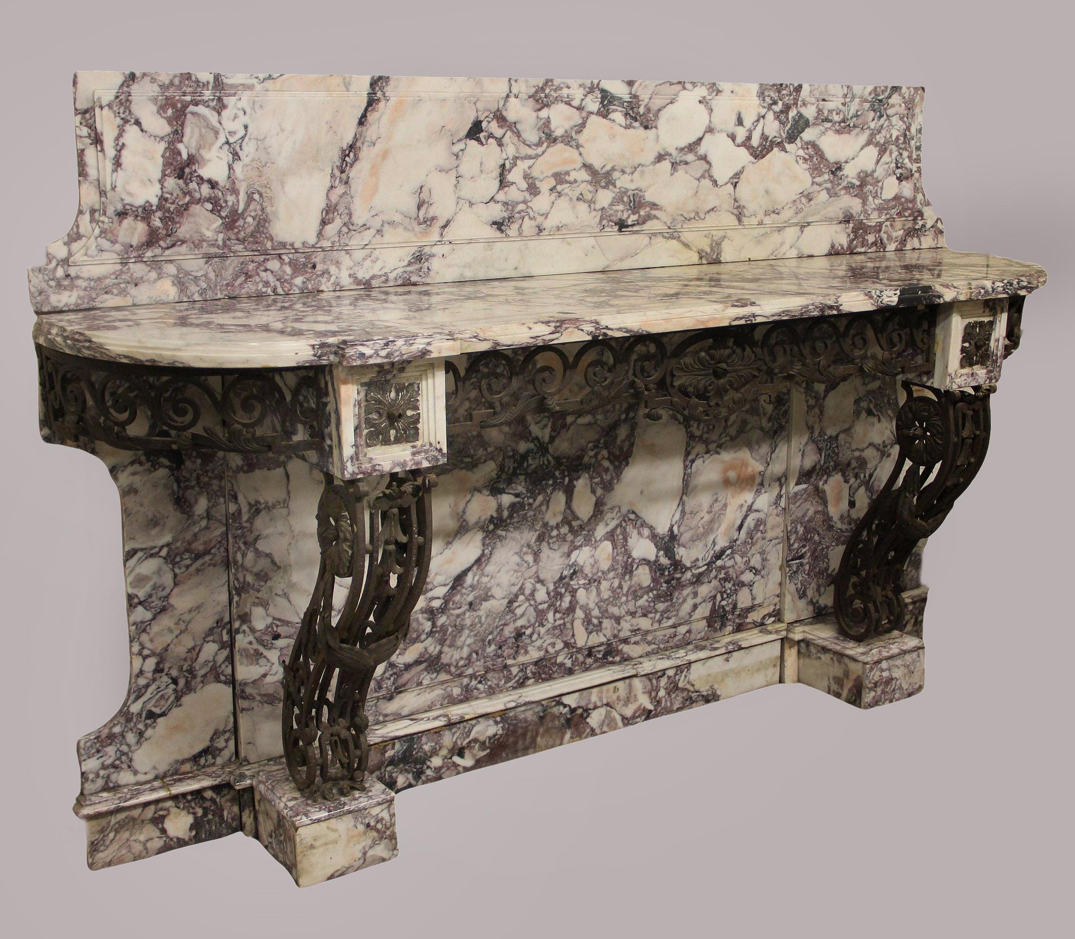 A Palatial Late 19th Century Louis XV Style Wrought Iron and Marble Console

The beautiful brocatelle marble backsplash and top above a wonderful designed iron rim and two shaped legs, the bottom with the matching backsplash and standing on