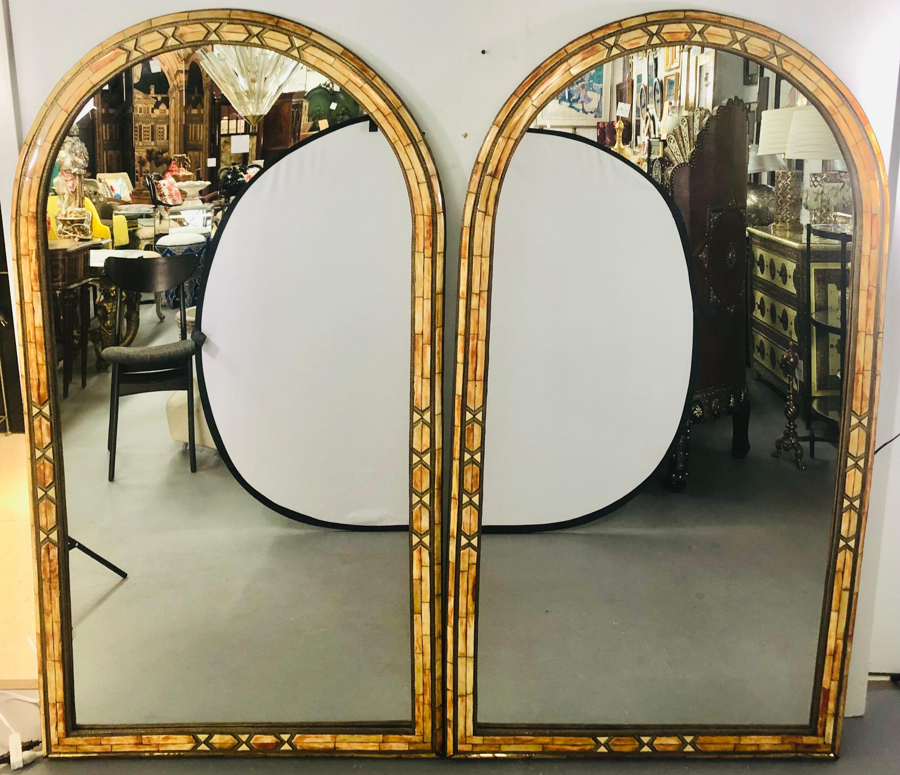 Wall console or pier mirror palatial Moroccan Hollywood Regency fashioned, pair
With generous pieces of orange camel bone set into a frame of brass, these uniquely constructed mirrors exude a muted, fiery glow and warm tones. The mirrors are