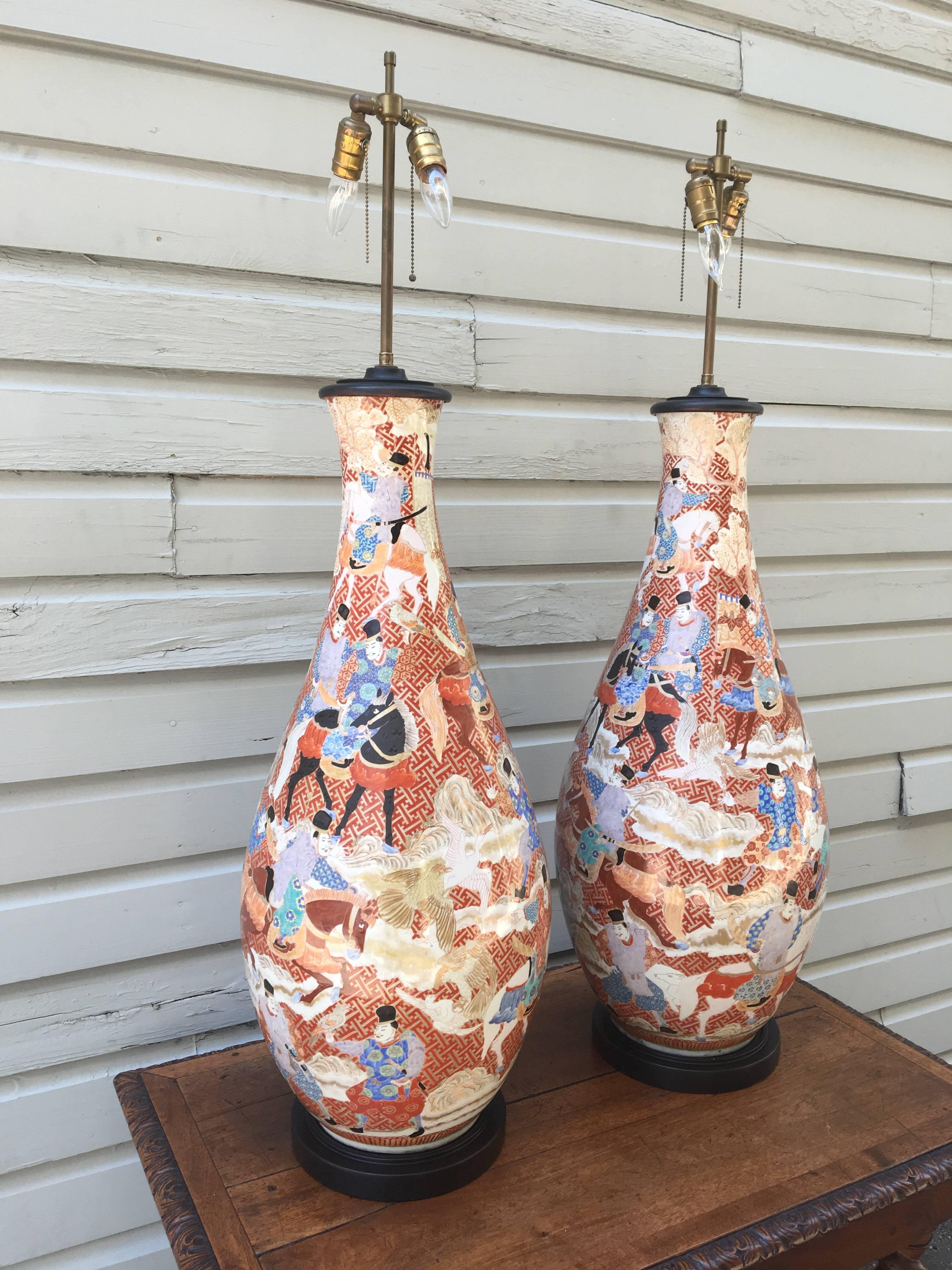A palatial pair of Japanese Kutani porcelain vases from the Meiji period, circa 1870, wired as lamps. The pair sand at approximately four feet in height and have a sophisticated yet earthy palette.