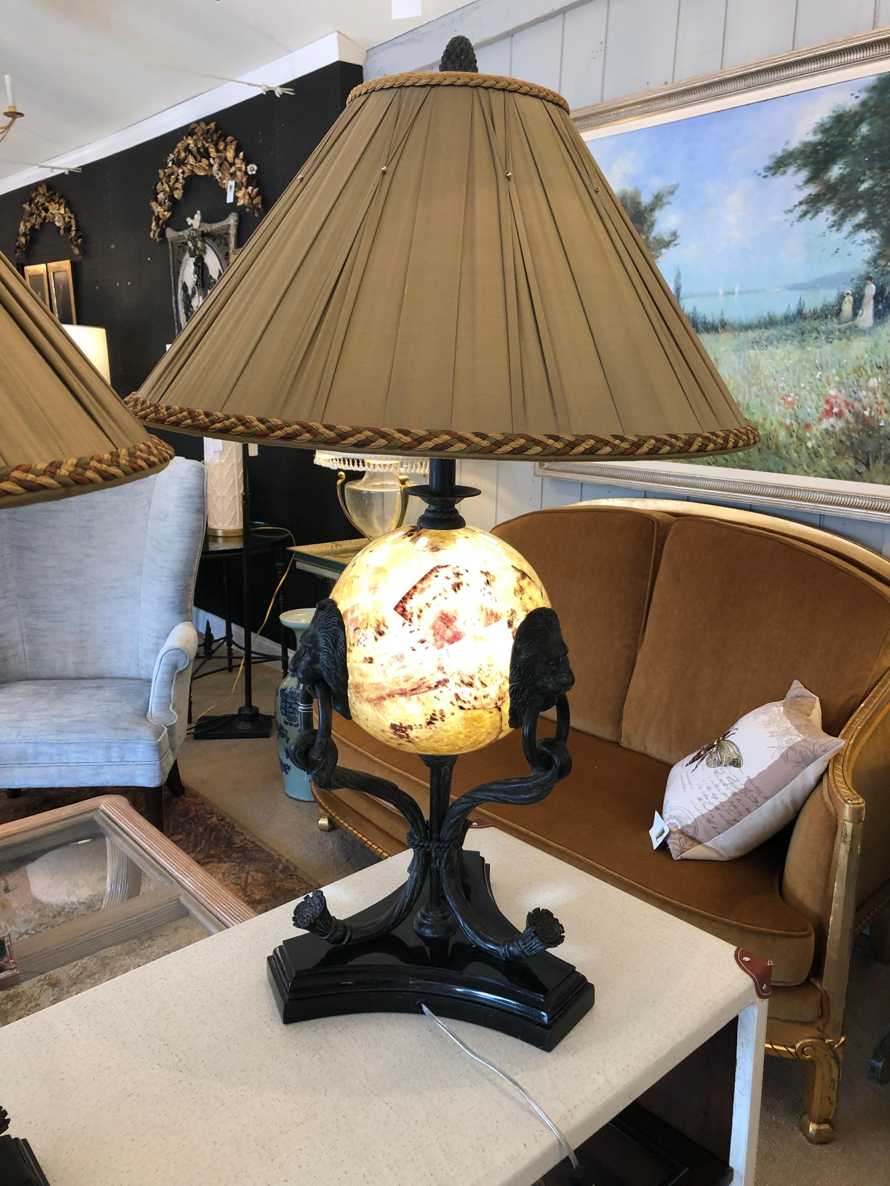 Impressive ornate pair of very fancy table lamps having shell orbs that are an additional source of light with a primary single socket above.  Bronze lions with rings in their mouths adorn the spheres and the bases have elaborate tripod shapes on