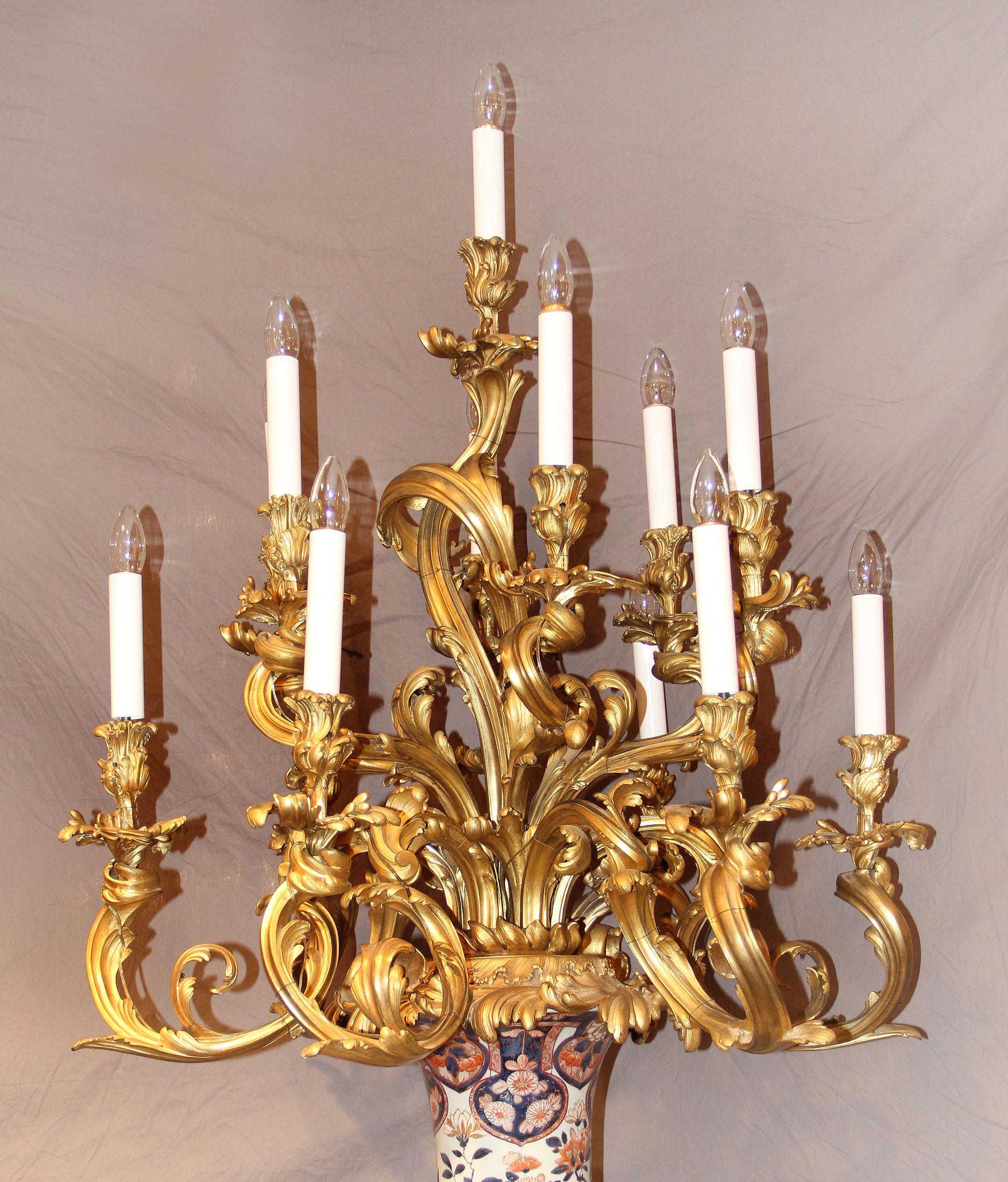 A Palatial pair of mid-19th century gilt bronze mounted Napoleon III Imari porcelain thirteen light torchères.

Each massive torchère with scrolled acanthus handles below the neck, thirteen bronze scrolled candle arms. Standing on wonderful