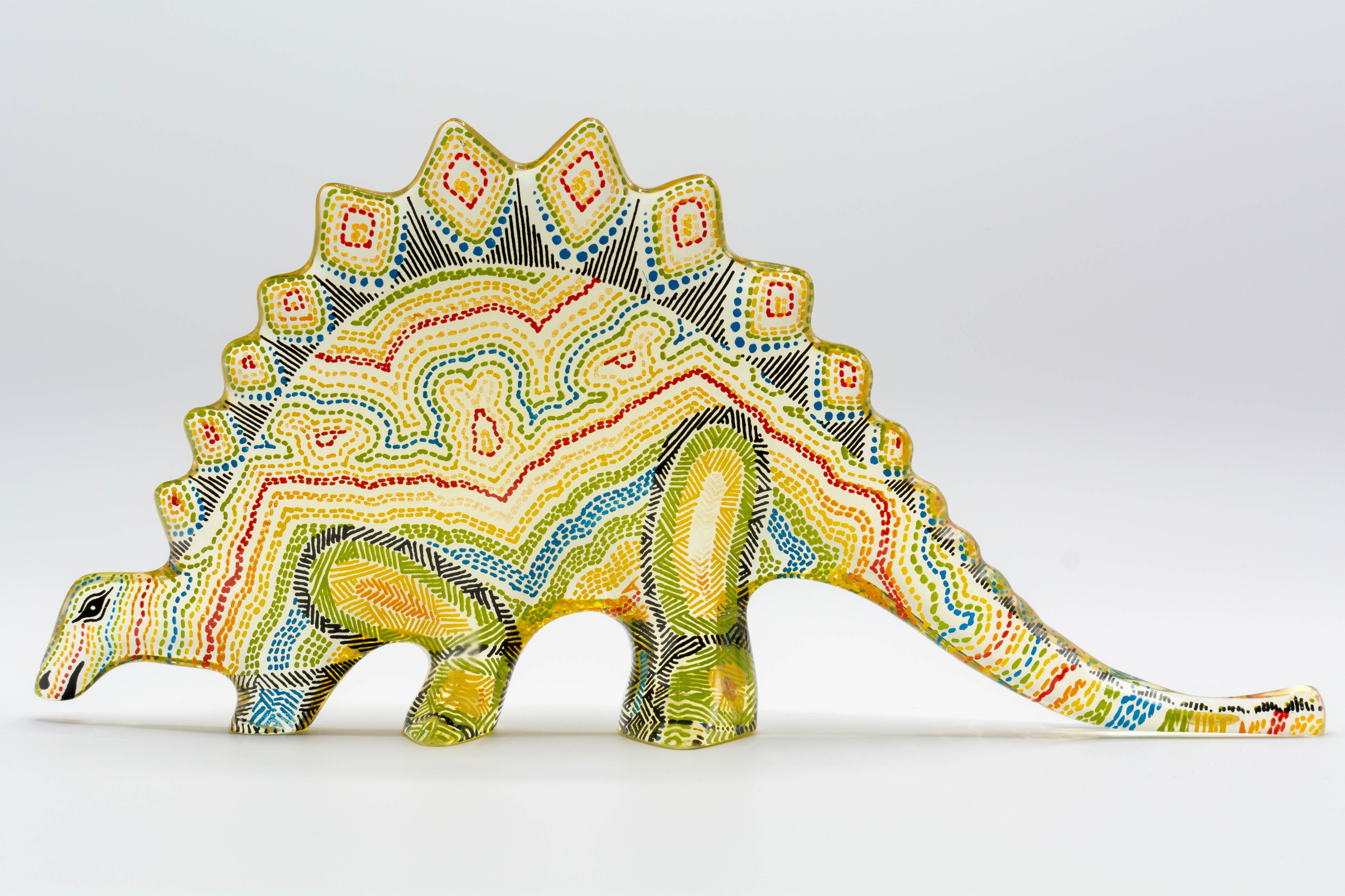A Mid-Century Modern Lucite Op Art dinosaur designed by Abraham Palatnik. A colorful stegosaurus in yellow, green, red and blue. Abraham Palatnik (born in 1928) is a Brazilian artist and inventor whose innovations include kinechromatic art. Part of
