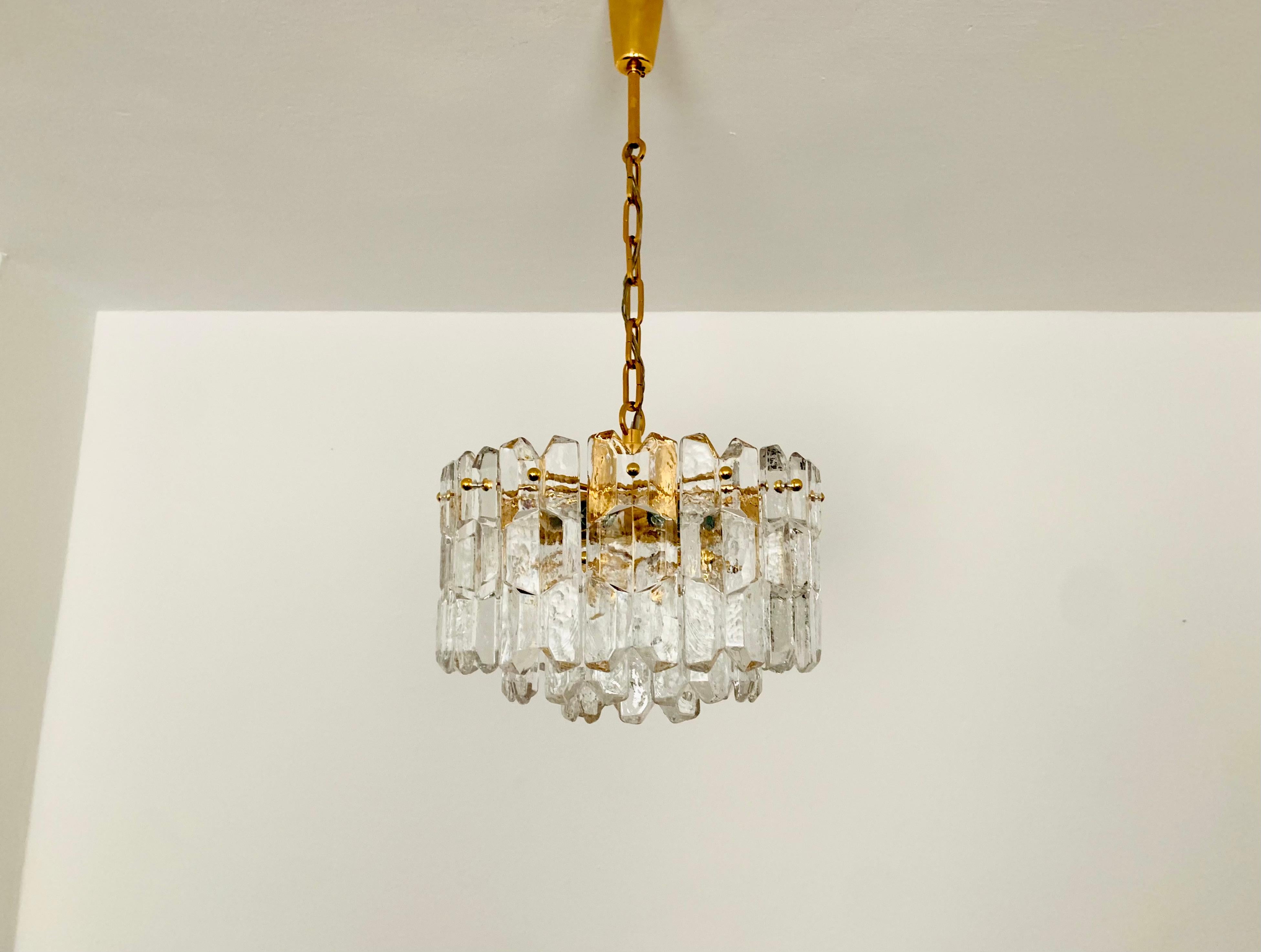 Wonderful ice glass chandelier from the 1960s.
The beautifully formed Murano glass elements create an impressive, sparkling play of light.
Exceptionally high-quality workmanship.
Very noble and luxurious appearance and a real eye-catcher for