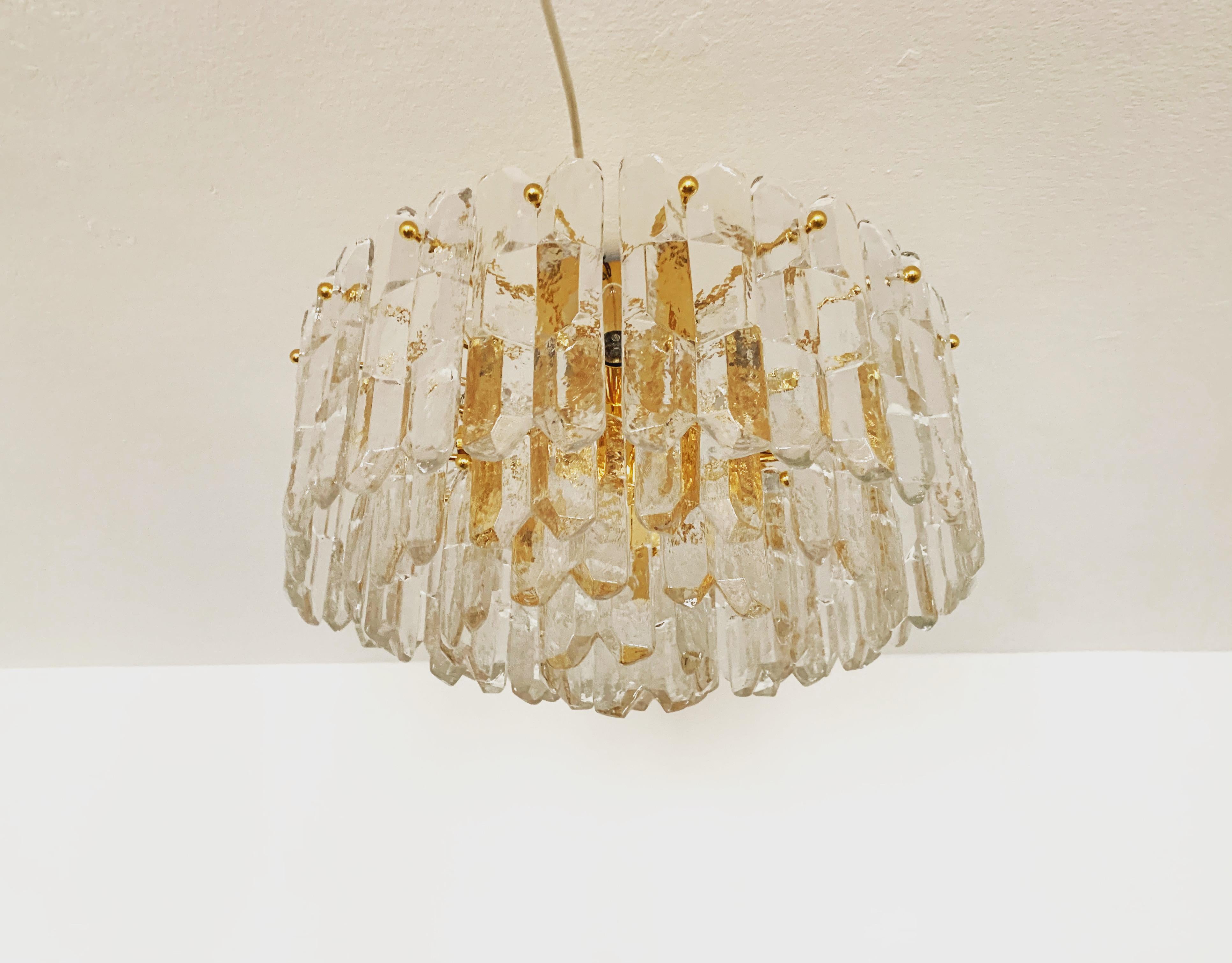 Wonderful and large ice glass ceiling lamp from the 1960s.
The 42 beautifully shaped Murano glass elements create an impressive, sparkling play of light.
Exceptionally high-quality workmanship.
Very noble and luxurious appearance and a real
