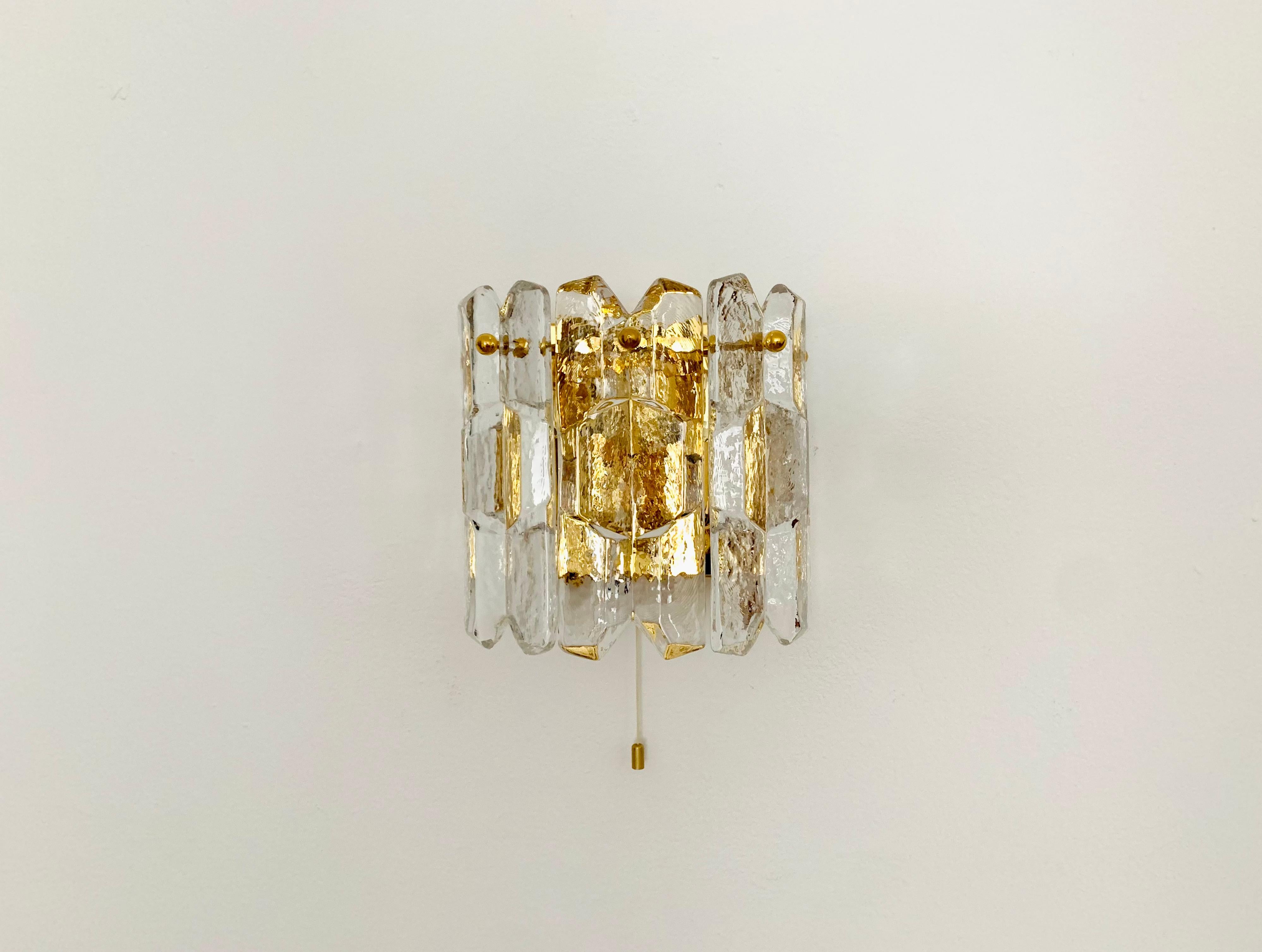 Very nice Palazzo wall lamp from the 1960s.
Very pleasant lighting effect due to the ice glass, which spreads an elegant, sparkling play of light in the room.
Great design and high-quality workmanship.

Manufacturer: Franken KG
Design: J.T.