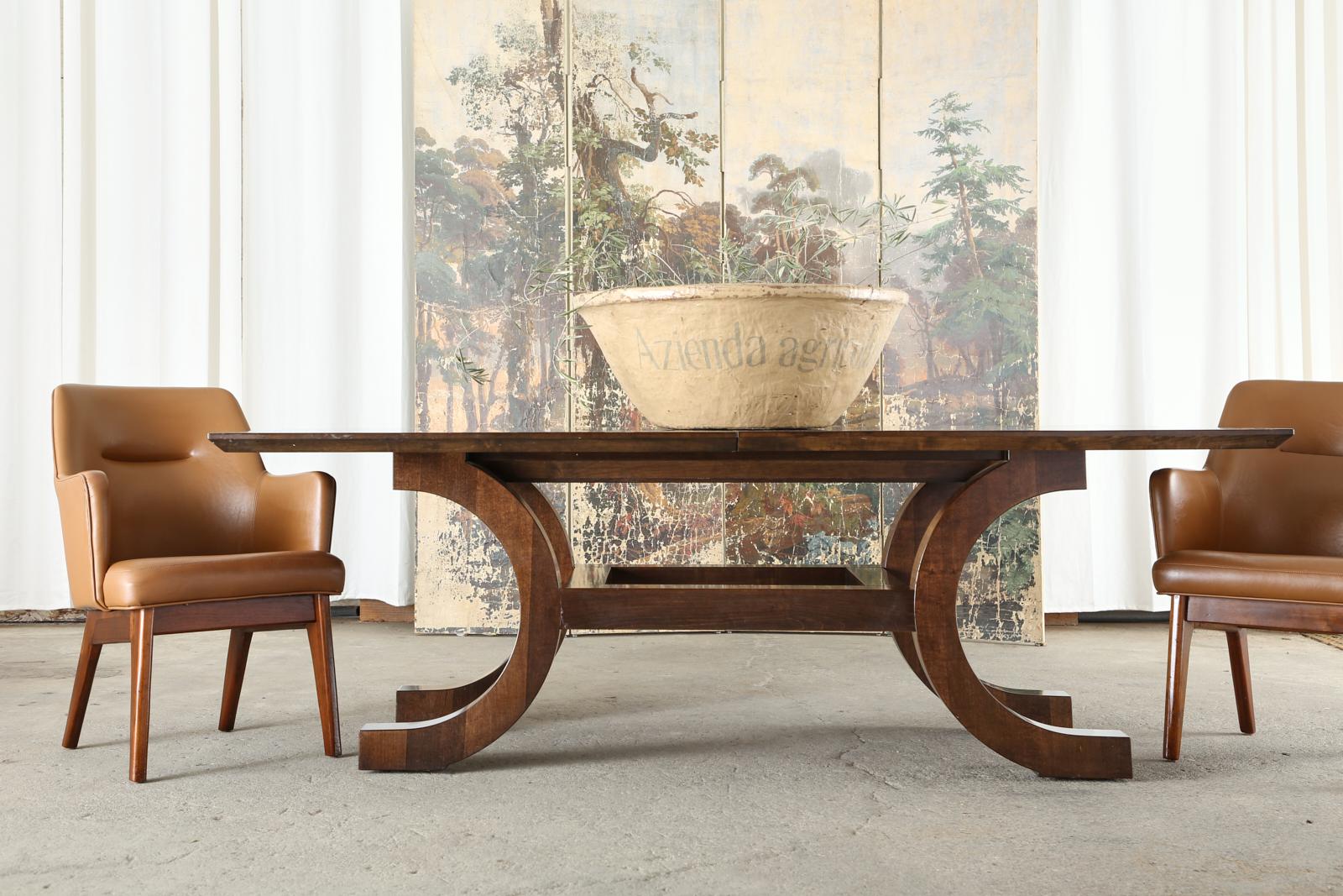 Chic modern walnut Palazzo dining table with two extending leaves designed by Orlando Diaz-Azcuy for McGuire. The table features an extending rectangular top that extends from 86 inches closed to 116 inches with both leaves installed. The base