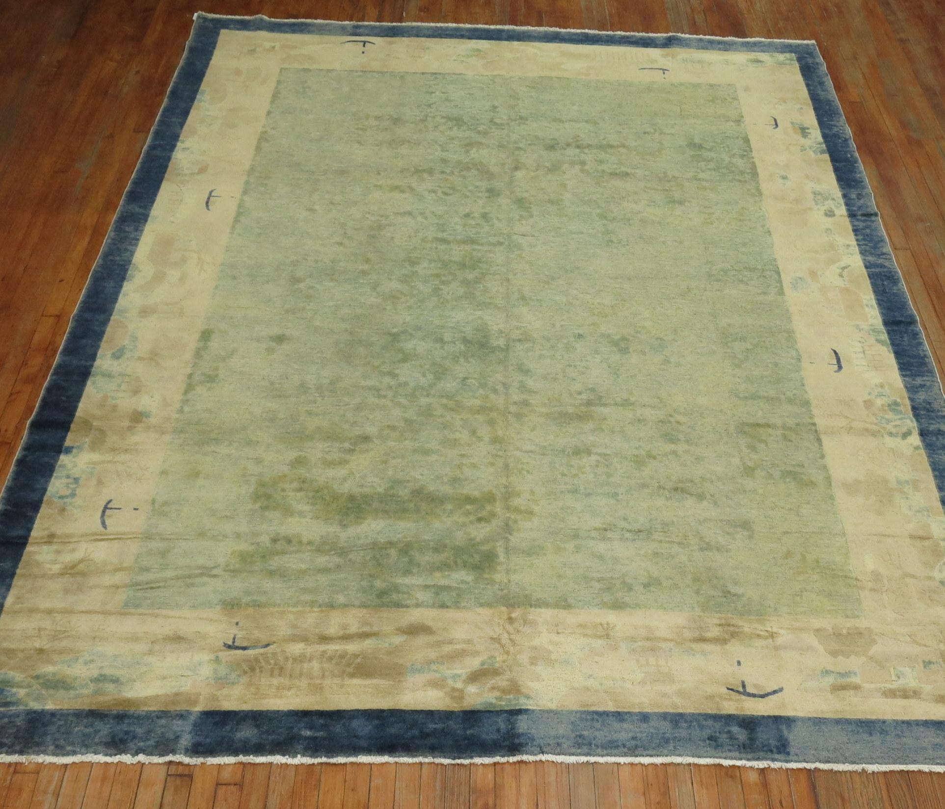 An early 20th century room size Chinese rug in various shades of blue. The wool and feel of the rug is very soft on the feet. It has a silky sheen to it as well.