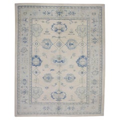 Alfombra Oushak Turca de Lana Tejida a Mano con Diseño Floral Azul Pálido y Beige 10'6" X 13'6"