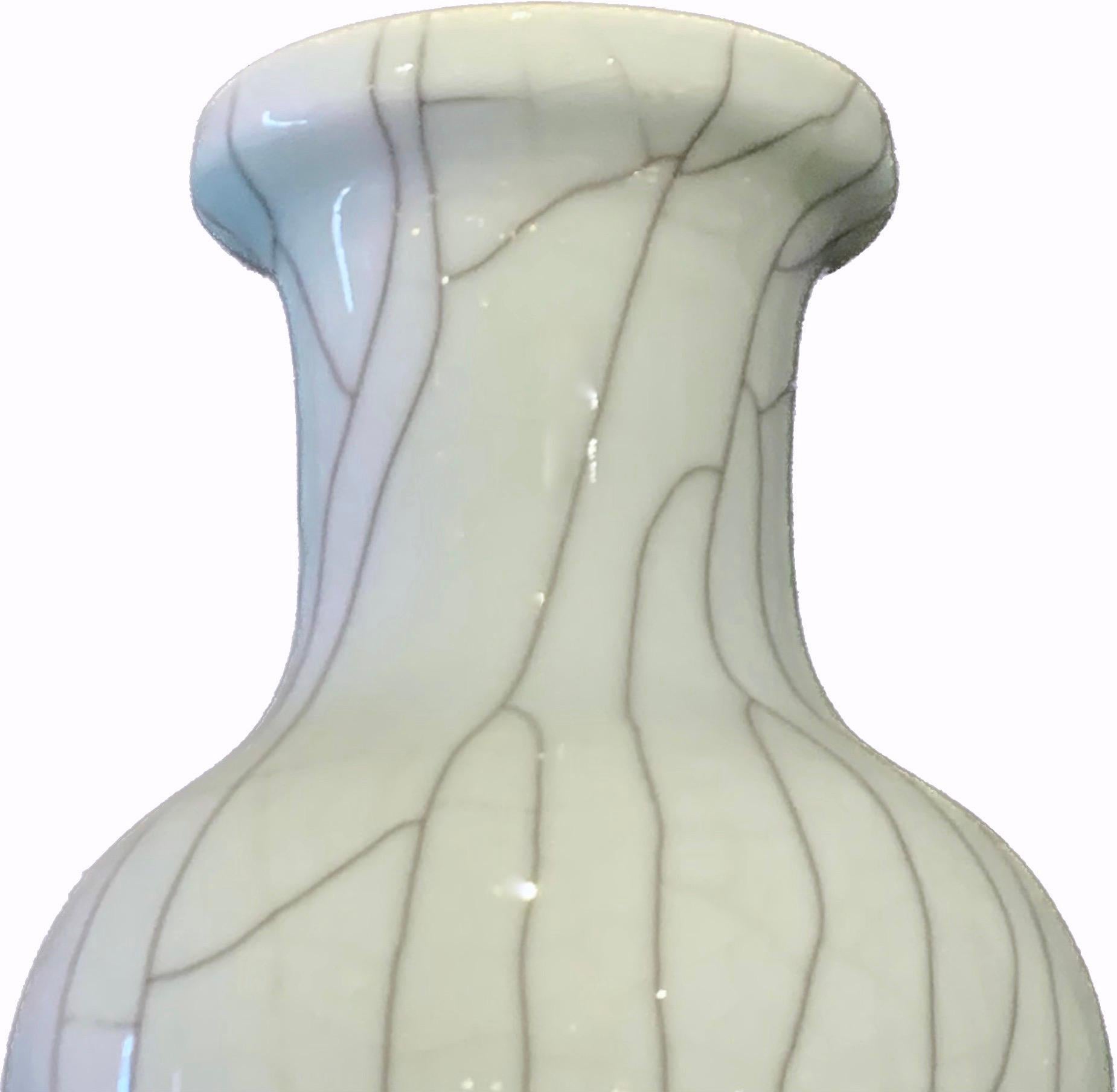 Contemporary Chinese washed pale blue crackle ceramic vase.
Handmade
Available in a similar shape with a different lip S4339B.

.