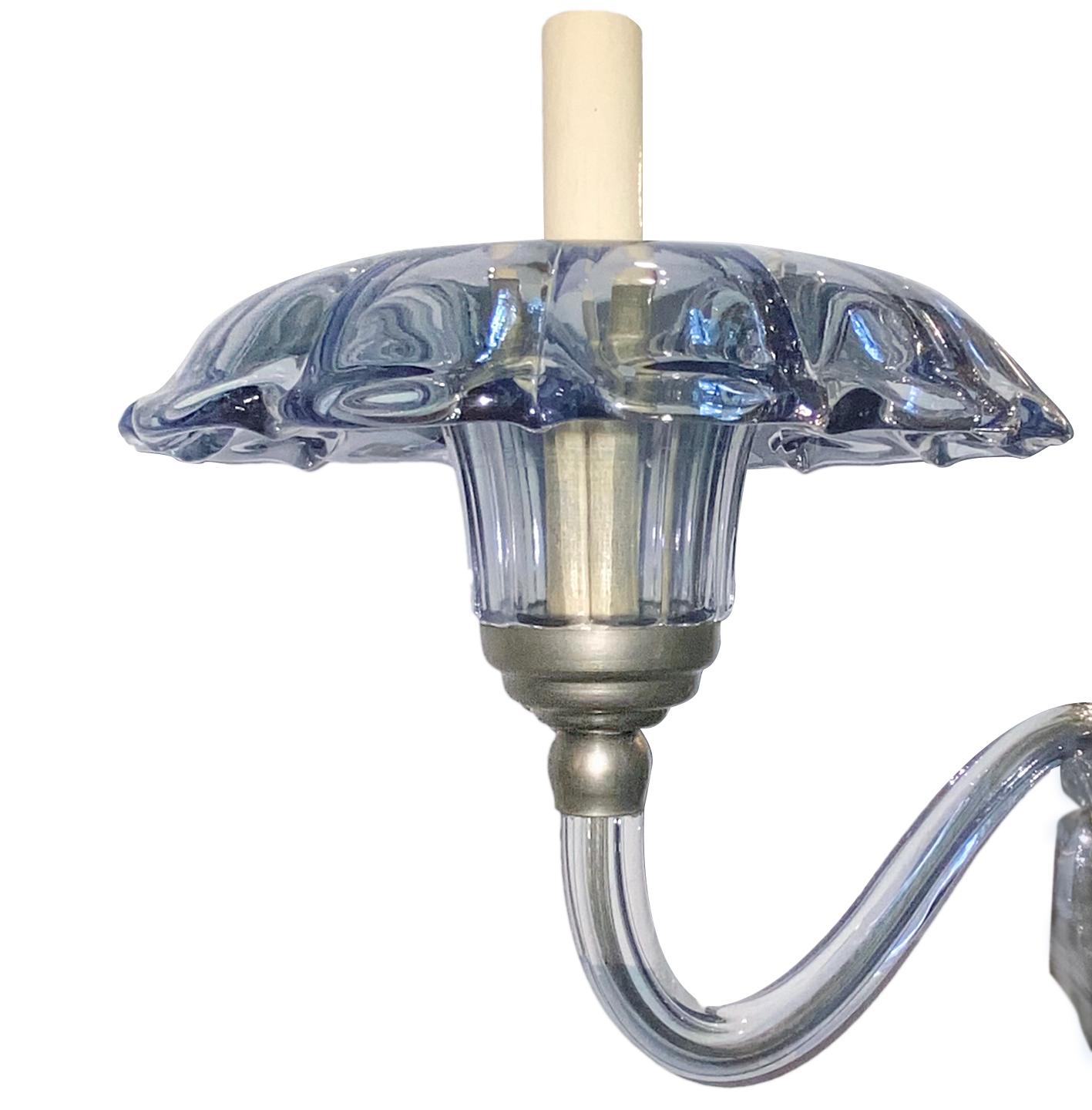 A circa 1950's light blue Murano glass eight-arm chandelier with a faceted body.

Measurements:
Minimum drop: 33.5