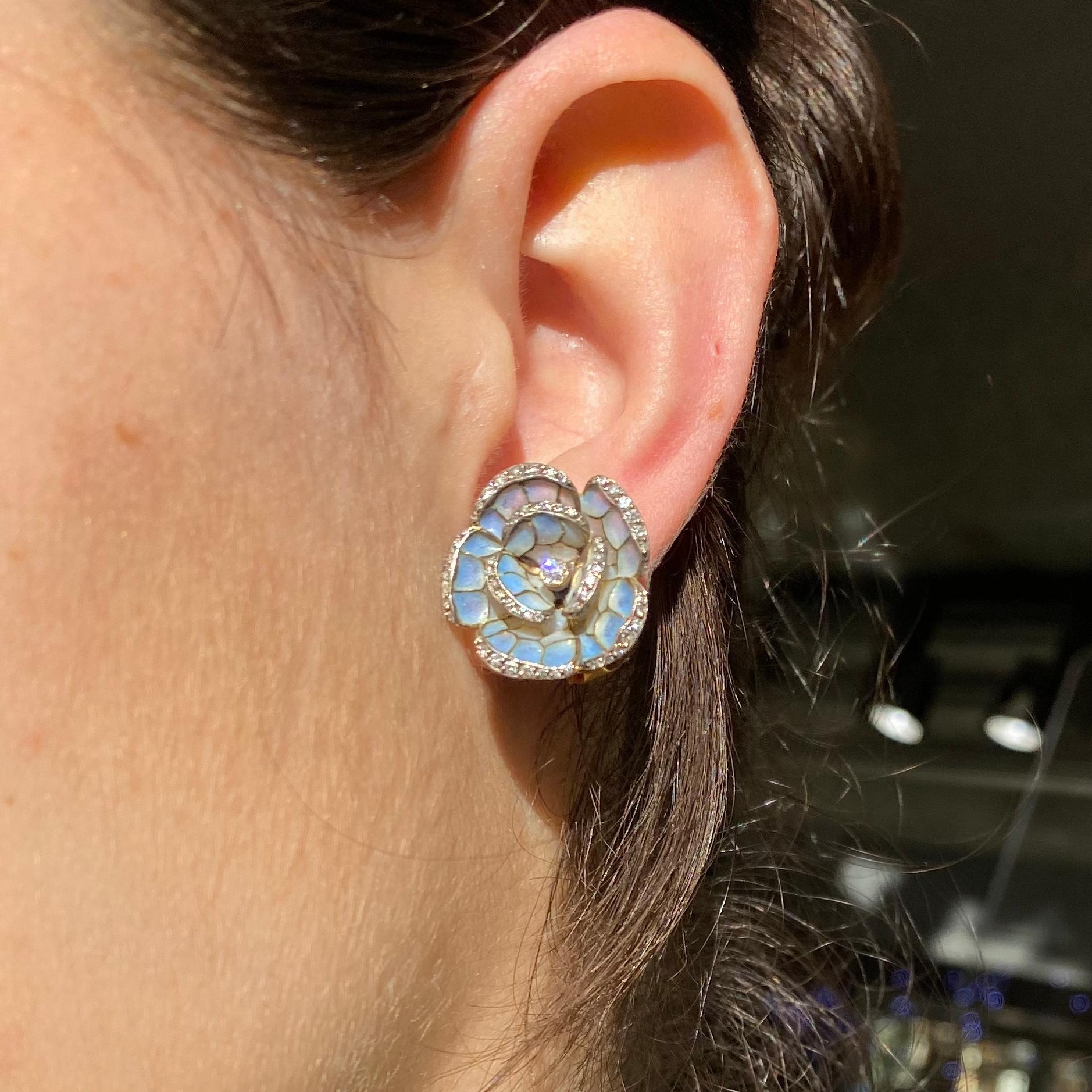 A pair of flower earrings, with two row, five petalled, flowers, with pale blue plique à jour enamel set with rose-cut diamonds, in silver settings, mounted in 18ct gold, with clip-on fittings.