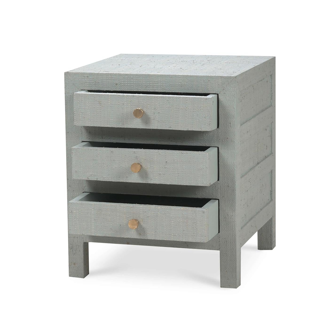 Wrapped in raffia, this stunning table combines modern design with coastal charm. It features three drawers for all your storage and bedside essentials.

The pale blue washed raffia finish adds a touch of elegance and warmth to any room while