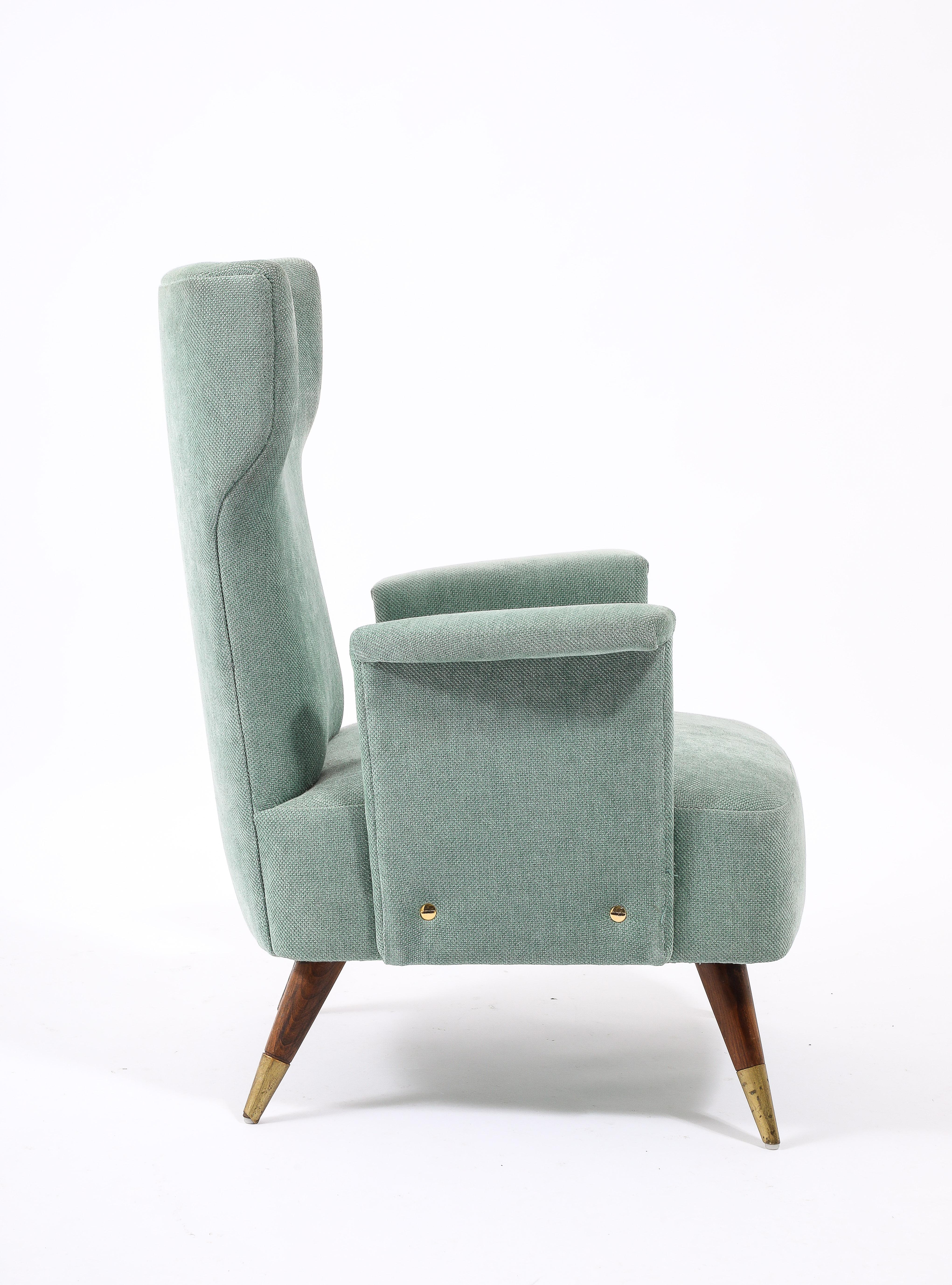 Pair of light blue cotton upholstered armchairs in the style of Paolo Buffa on cherry legs with brass accents.
