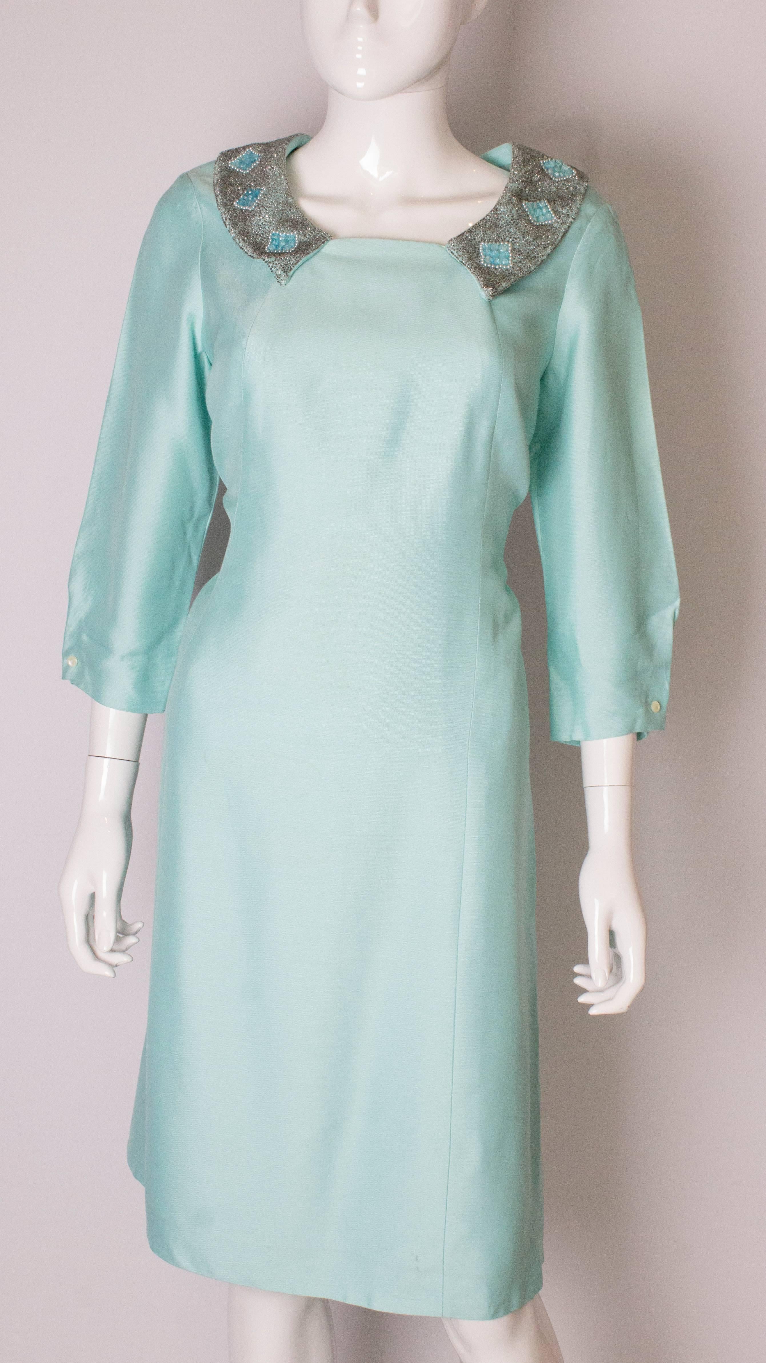 A lovely shift dress by Petite Francaise. In a pretty  pale blue colour the dress has pretty beaded collar and elbow length sleeves. it is fully lined with a central back zip.