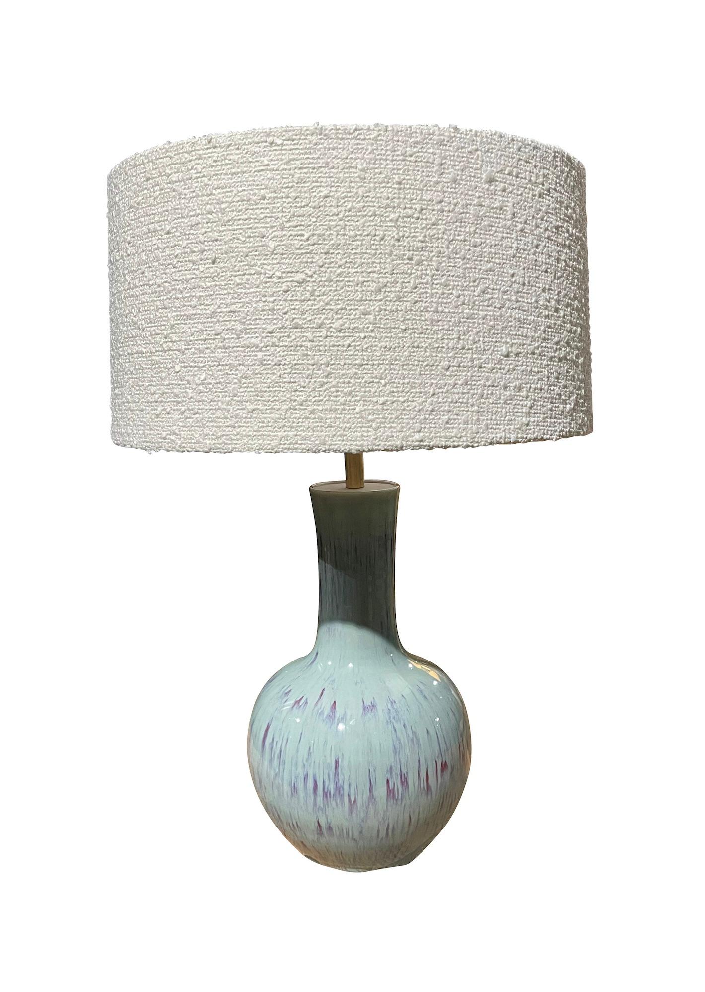 Contemporary Chinese pair of funnel neck shaped lamps.
Pale blue with decorative purple drip glaze design.
Boucle shades includes.
Base measures 8