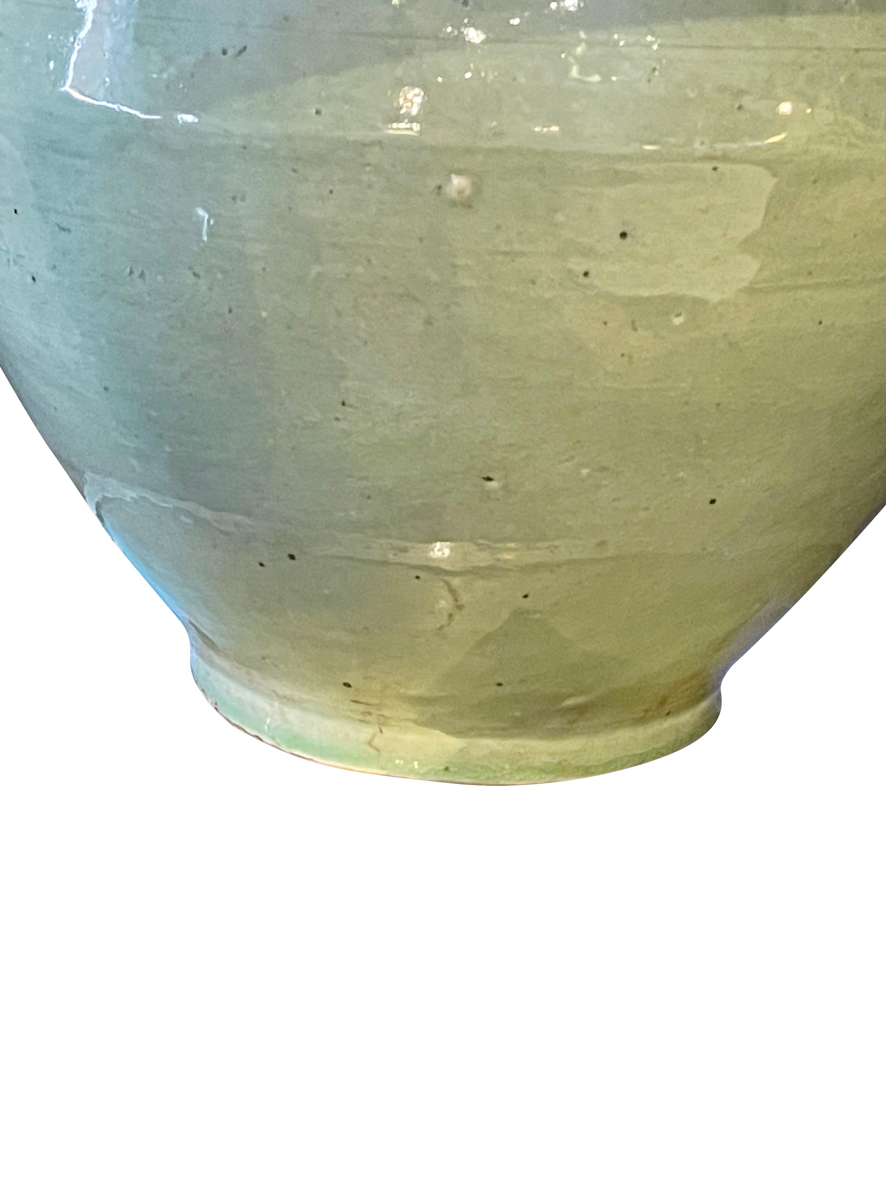Contemporary Chinese pair pale celadon glazed lamps with ginger jar shape.
New Belgian linen shades.
Base 9