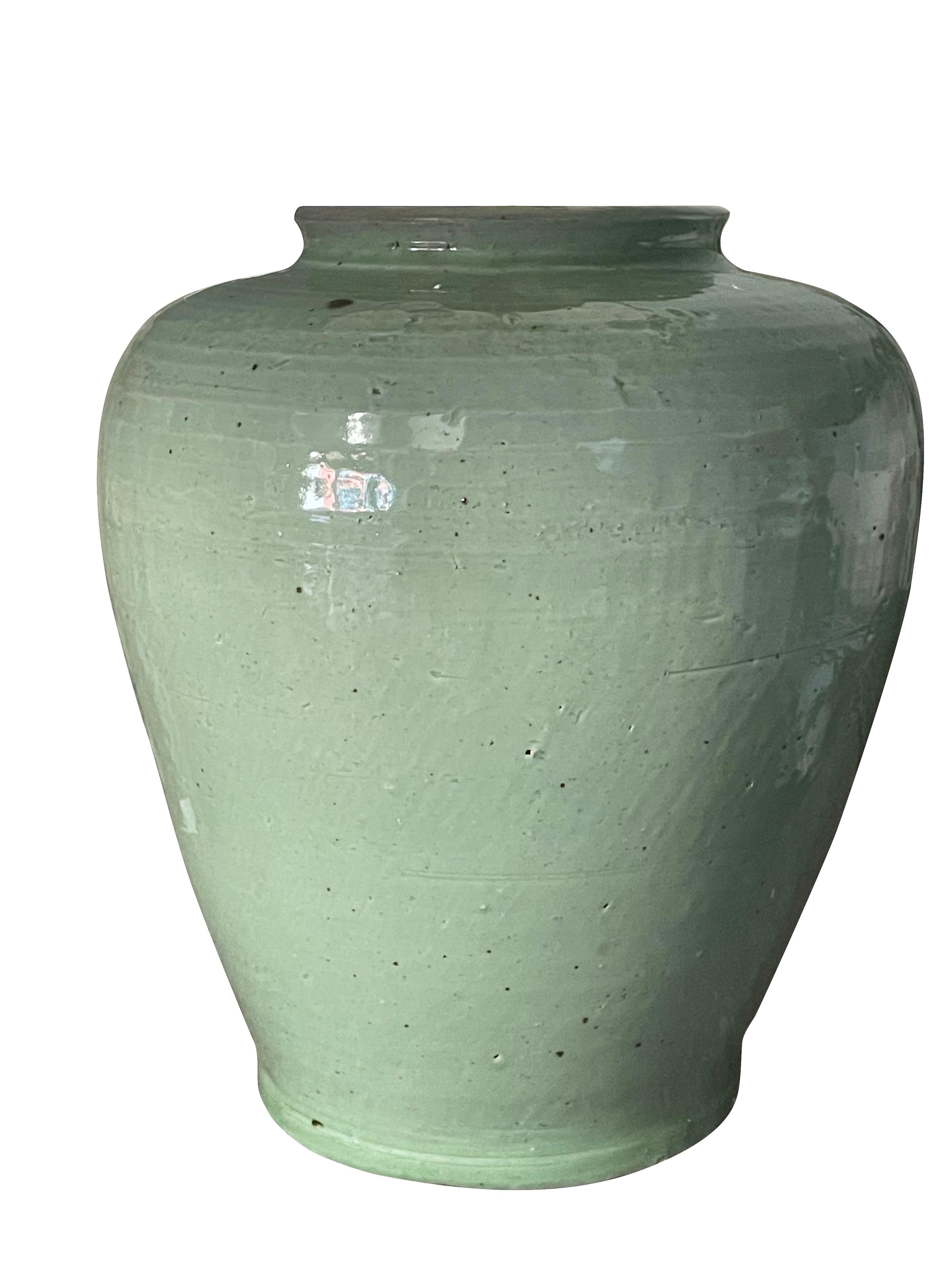Contemporary Chinese pair of pale celadon glazed ceramic lamps
Ginger jar shape
Base measures 9 D x 11 H
Belgian linen shades
Shade diameter 17.5