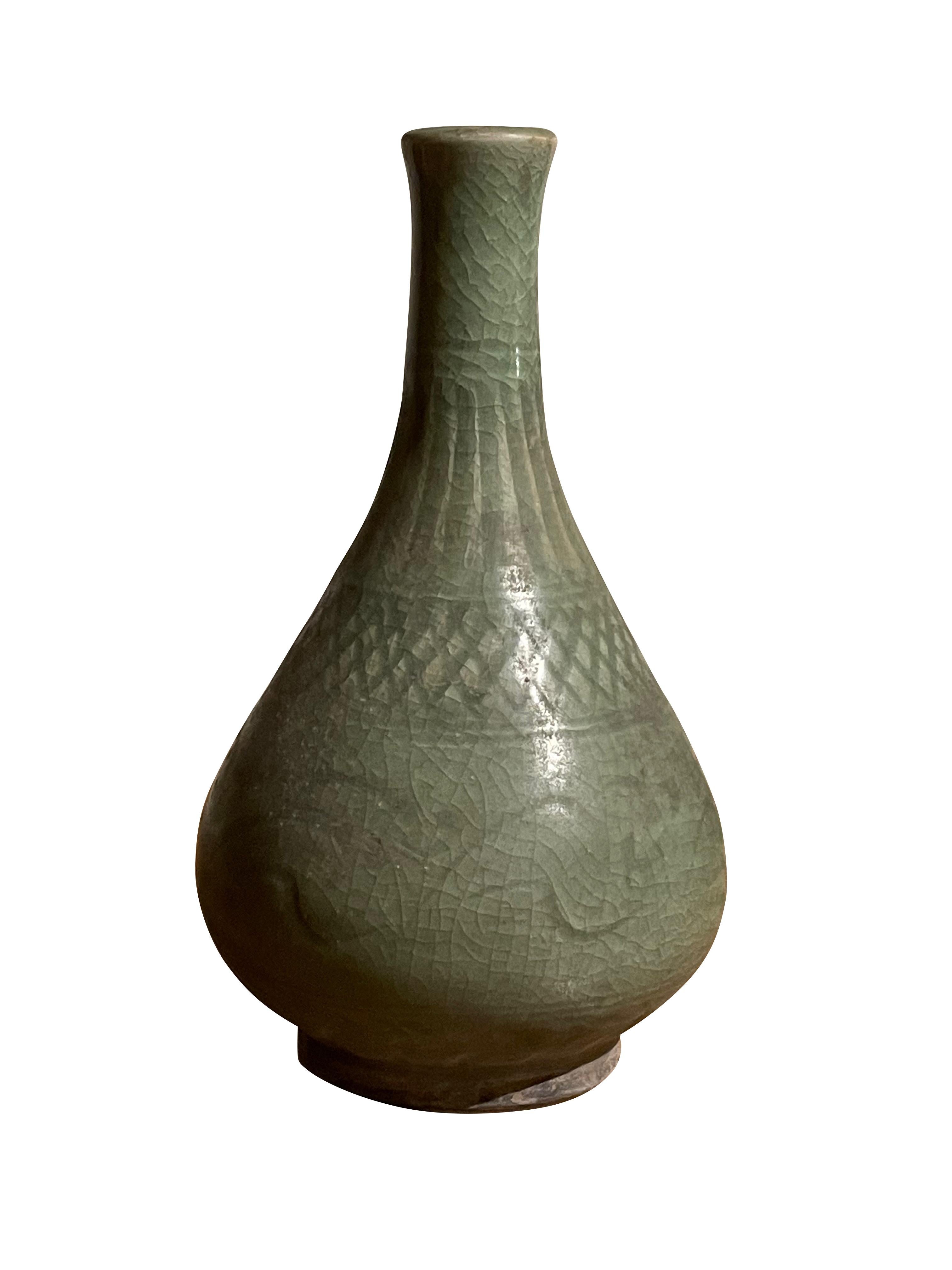 Contemporary Chinese pale celadon vase with decorative surface pattern.
Crackle finish glaze.
Slender neck with small opening.
Decorative crisscross pattern.
From a large collection.
ARRIVING MARCH