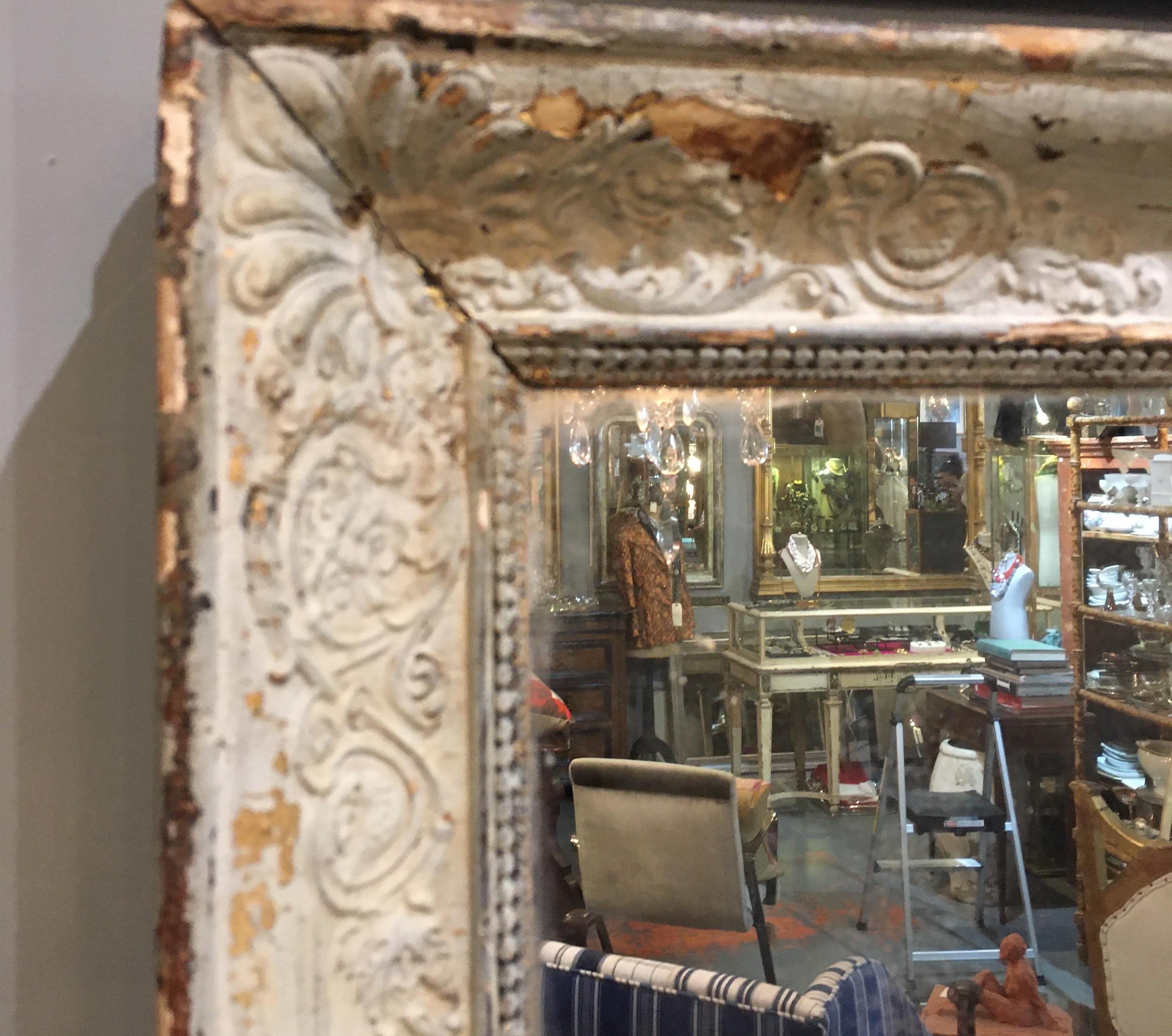 Distressed 19th century rectangular mirror from France with pale mint green / cream painted frame. Old mirror with lots of foxing and diamond dust in the mirror at corners.
           
