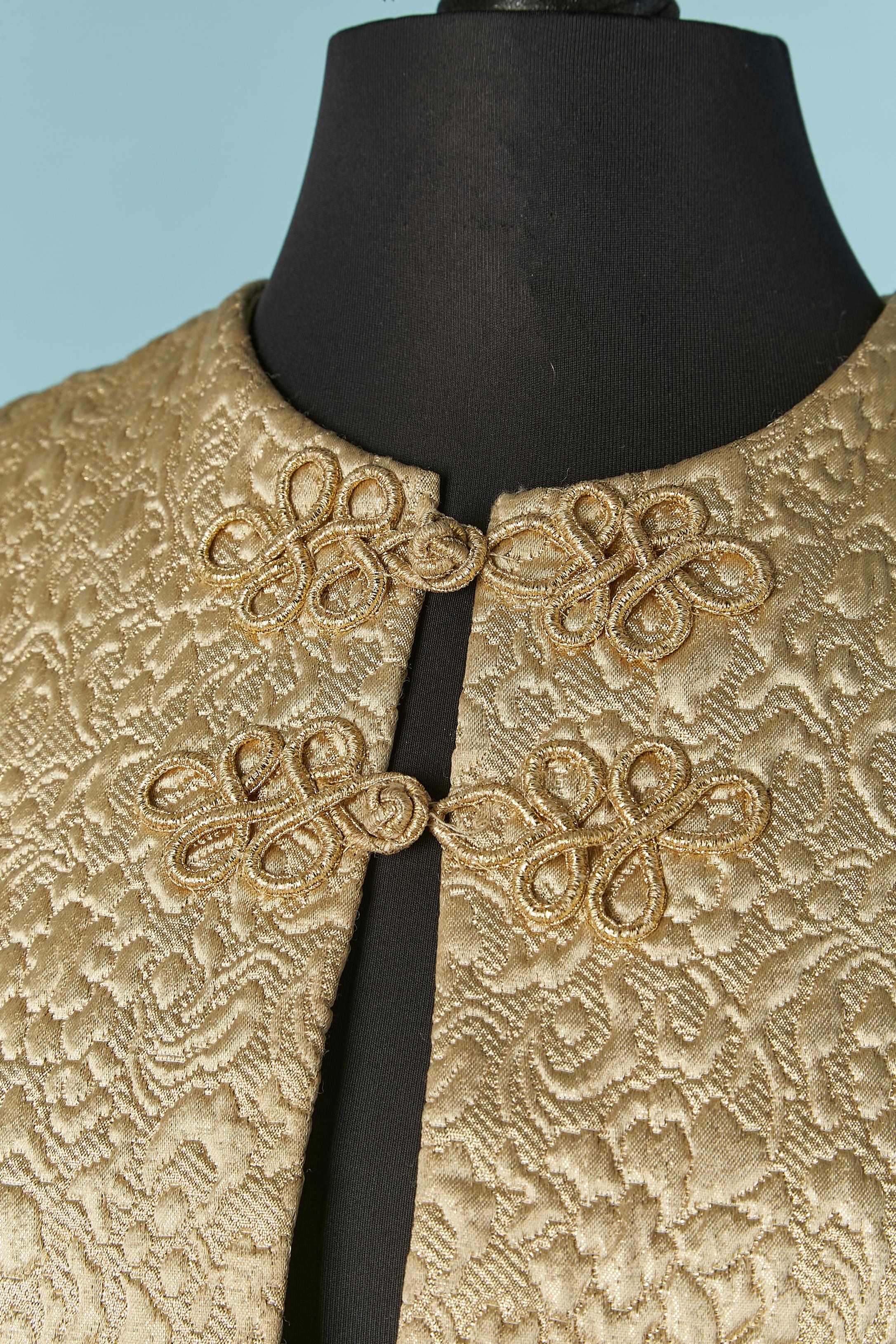 Pale gold brocade evening coat with gold lurex passementerie brocade closure on the top middle front. Ivory satin lining. 
SIZE S 