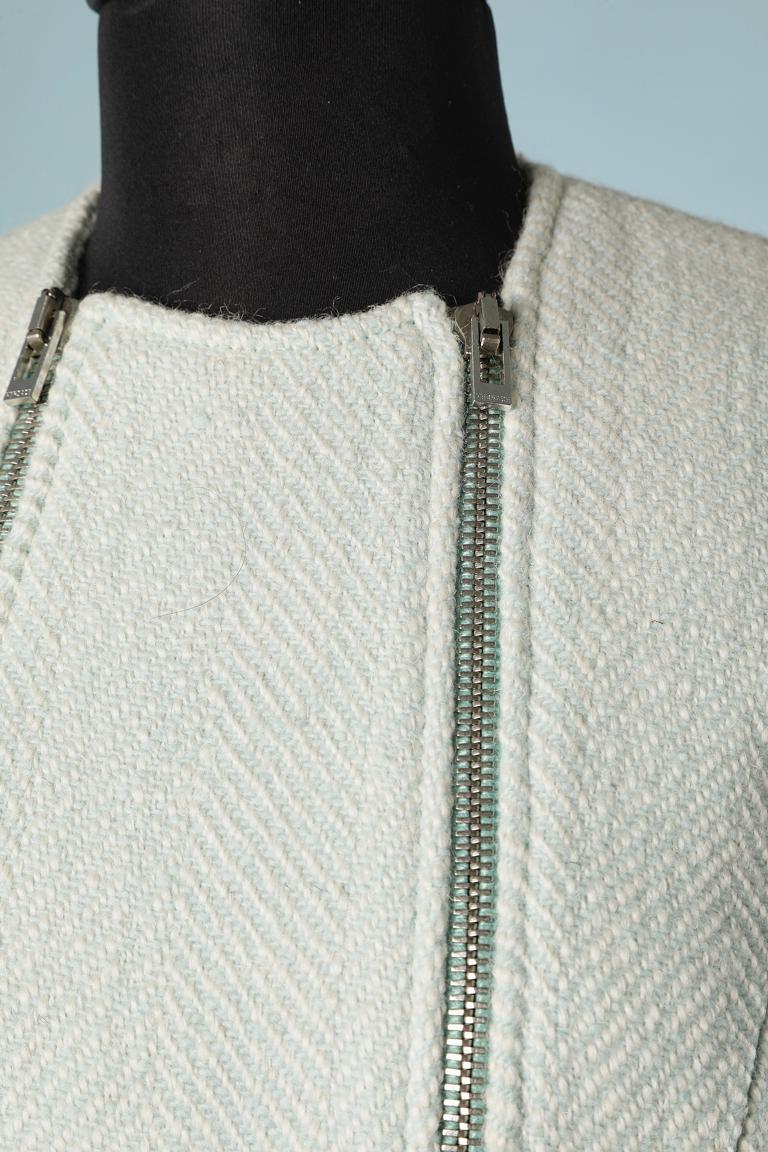 Pale green and off-white tweed chevron jacket with double zip. Zip on the pocket as well. Shoulder pad. Branded lining ( Medusa pattern) 
SIZE M