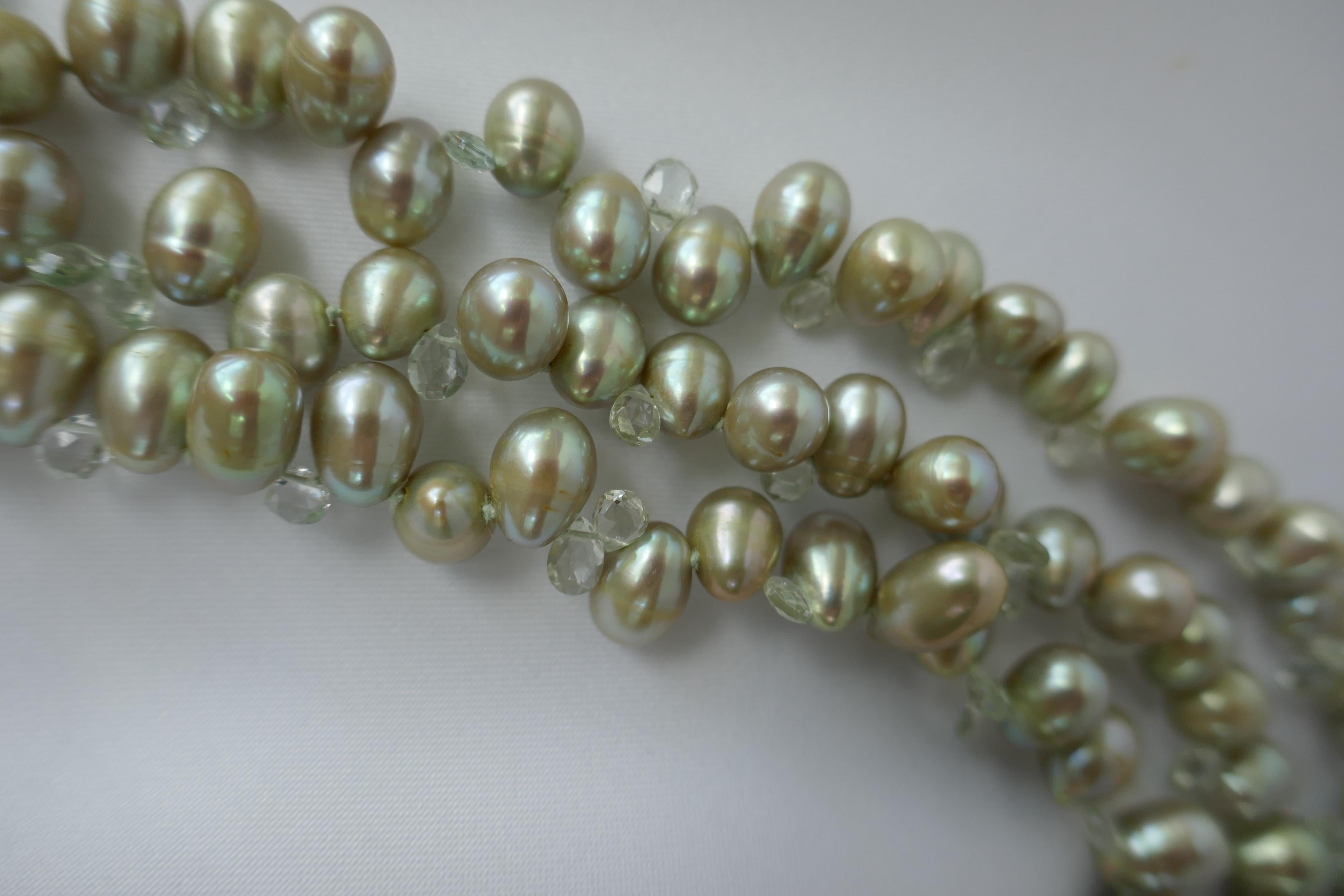 This three strand necklace is 8-8.5mm pale green drop cultured pearls interspersed with basket cut yellow beryl.  Beryl is a gemstone that comes is a variety of colors. The most well know are emerald, which when the beryl is deep green in color is