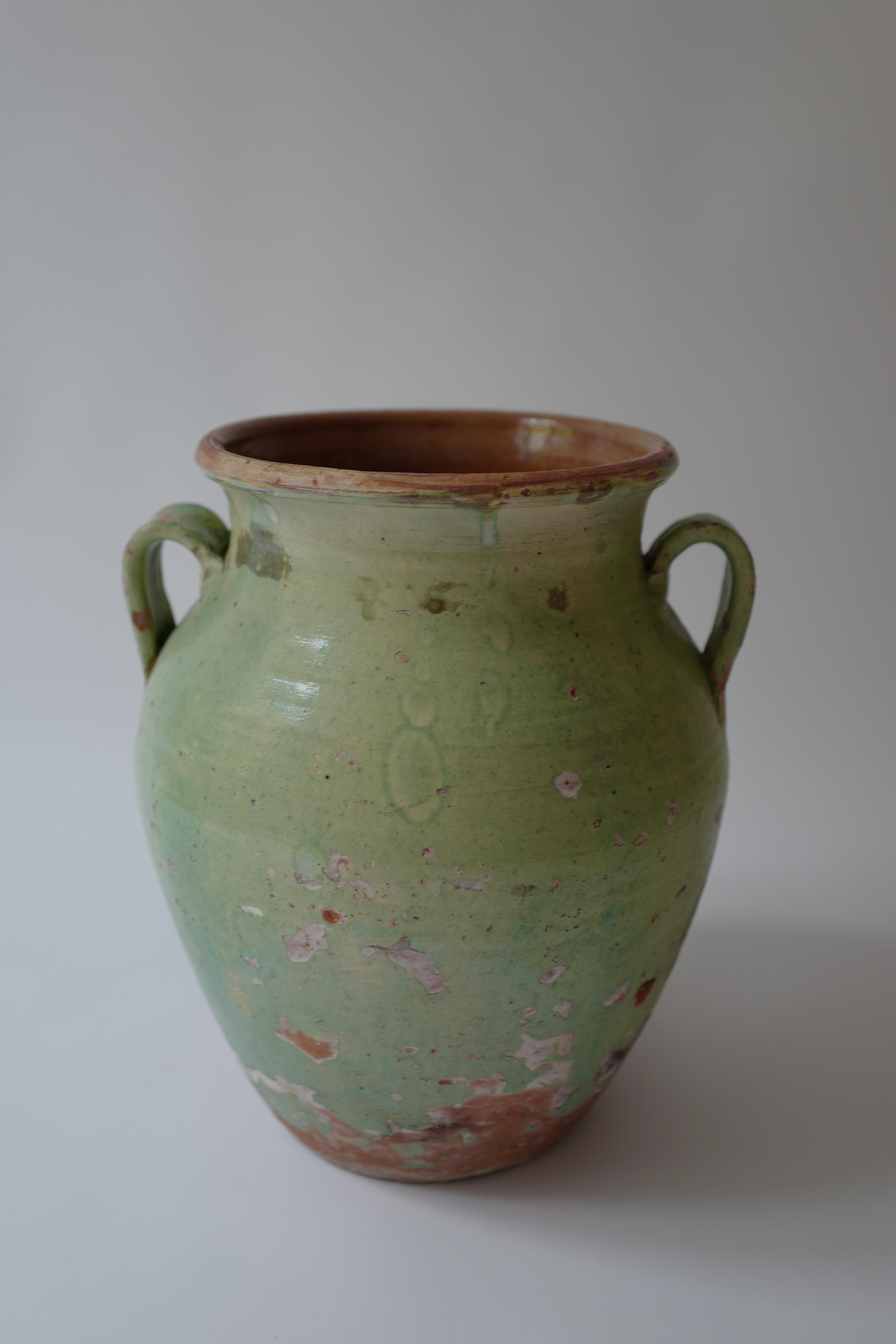 Rare pale green glazed terracotta pot from France. Really beautiful time worn patina. Interior has a light brown glaze.