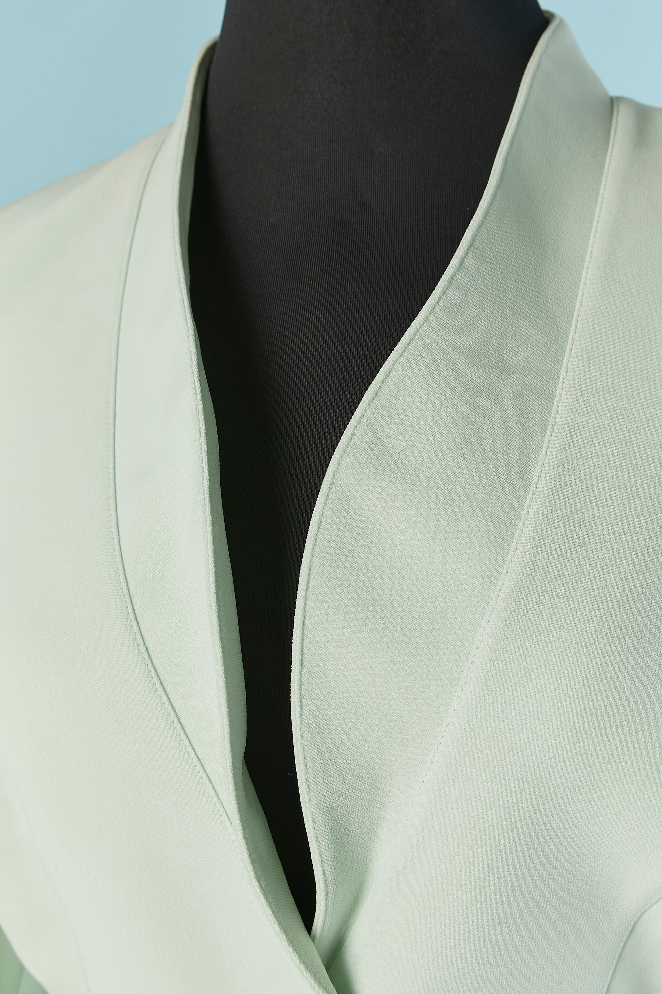 Pale green single breasted skirt suit . Main fabric composition: 100% polyester. Lining: 100% acetate. 
Snap closure on the middle front. Split on both side and on the cuffs. Shoulder pad. 
SIZE 42 / M 