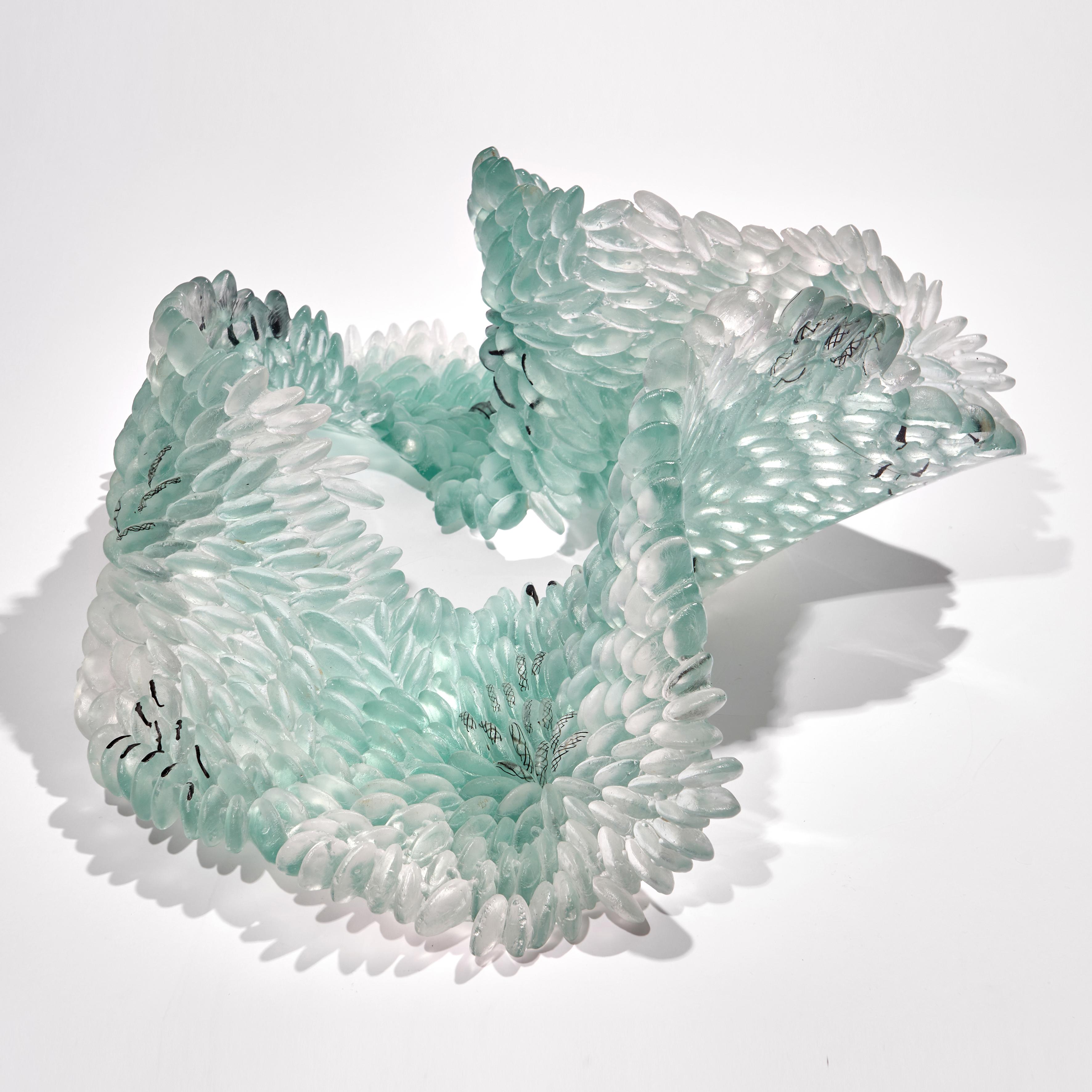 Pale Lichen is a unique textured glass sculpture in soft jade green, light grey and black by the British artist Nina Casson McGarva.

Casson McGarva firstly casts her glass in a flat mould where she introduces all of the beautifully detailed,