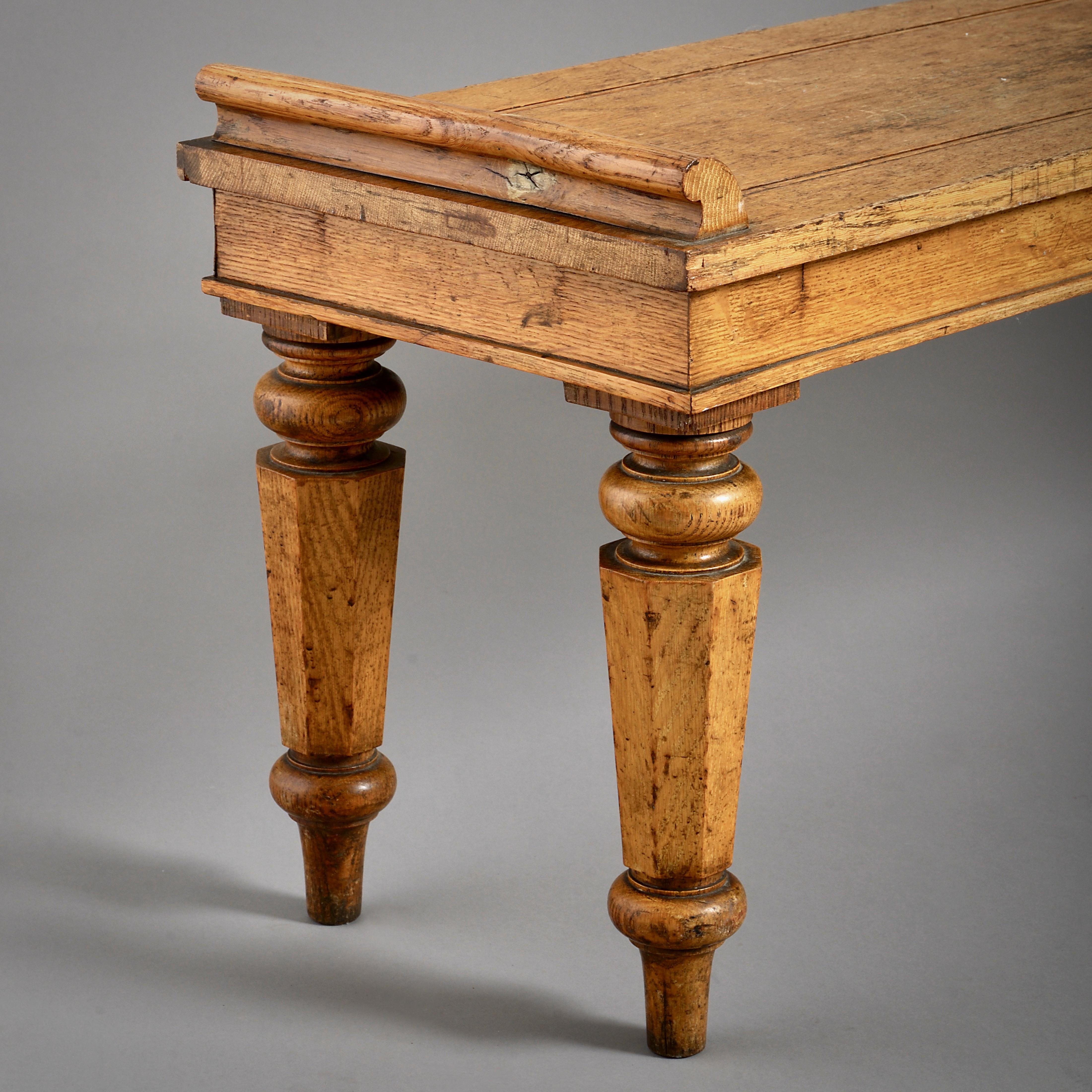 An early Victorian pale oak hall seat, circa 1840.