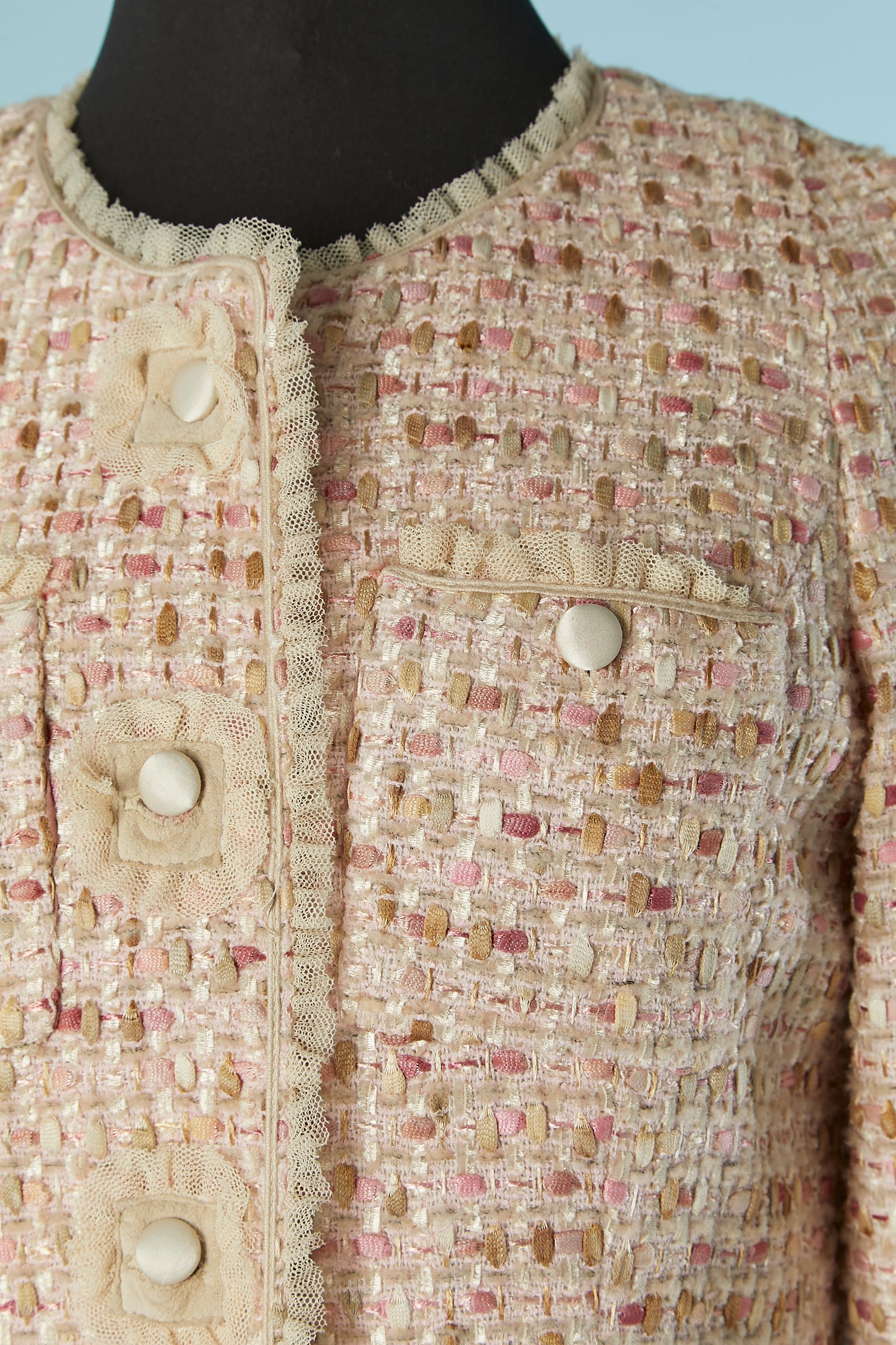 Pale pink and beige tweed single breasted coat with tulle ruffle. Tweed composition: 37% nylon, 29% wool, 17% cotton, 17% polyester. Tulle ruffles edge. No fabric composition tag for the lining but it's probably rayon changeant. 
Satin button and