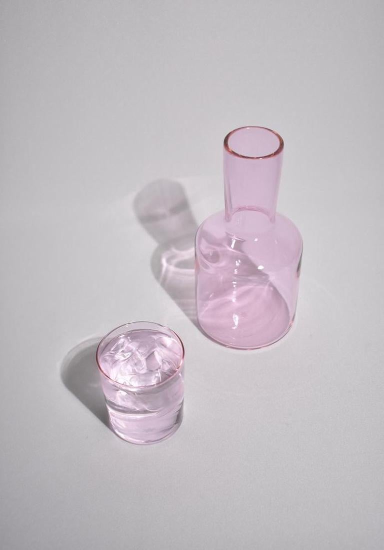 Pale pink carafe set by Maison Balzac inspired by the traditional sets used in France and displayed on a bedside table at night. 

Food grade colored glass, individually mouth blown. 
Heat and cold resistant.
Hand wash