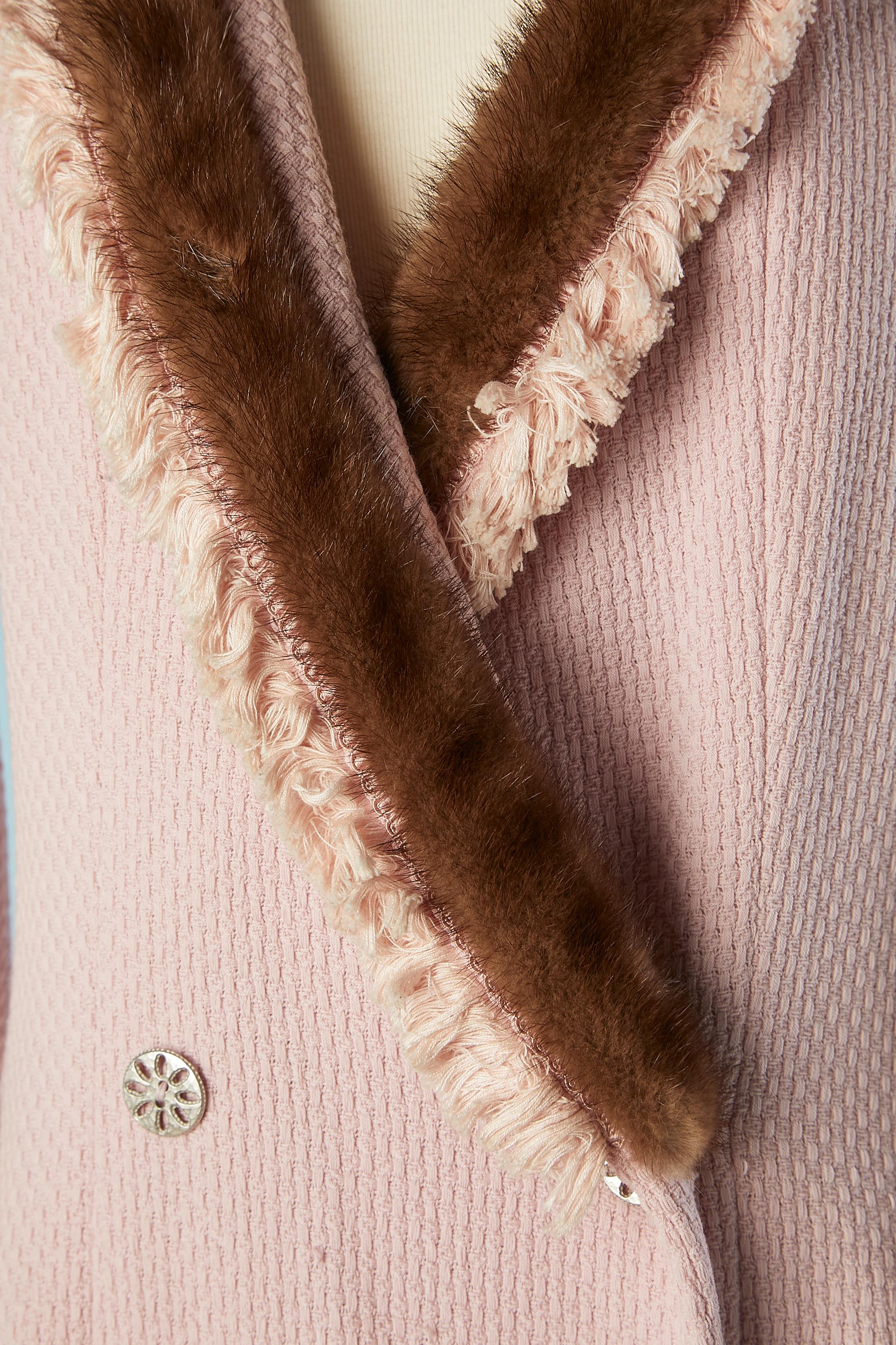 Zweireihige Jacke aus blassrosa Baumwoll-Tweed mit Nerz, Passepartout-Borte und Baumwollfransen am Saum. Silberne Metallknöpfe (und 2 rosa Plastikknöpfe innen) Seidensatin mit Markenzeichen  Futter. 
Raglanärmel. Diese Jacke wurde von Gianfranco