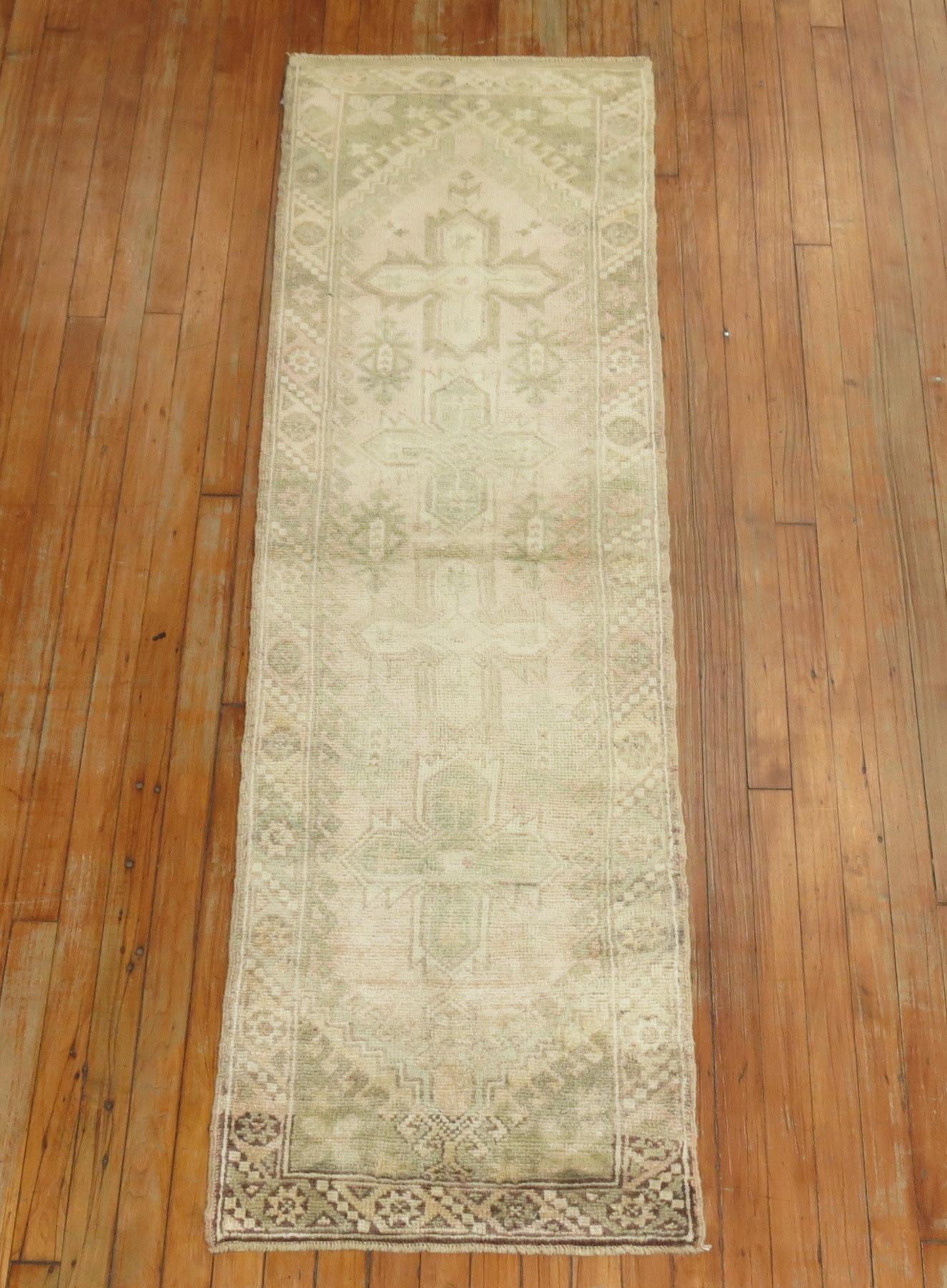 Pale one of a kind Vintage Turkish Oushak runner with 4 small medallions on a pale pink ground and soft green and brown accents.

circa 1940, measures: 1'10