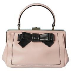 Pale pink leather top handle bag with black leather bow Kate Spade