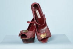 Pale pink sandal with a " gros-grain" bow and metal Nina Ricci