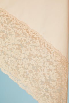 Pale pink satin deshabillé with lace on the sleeve edge