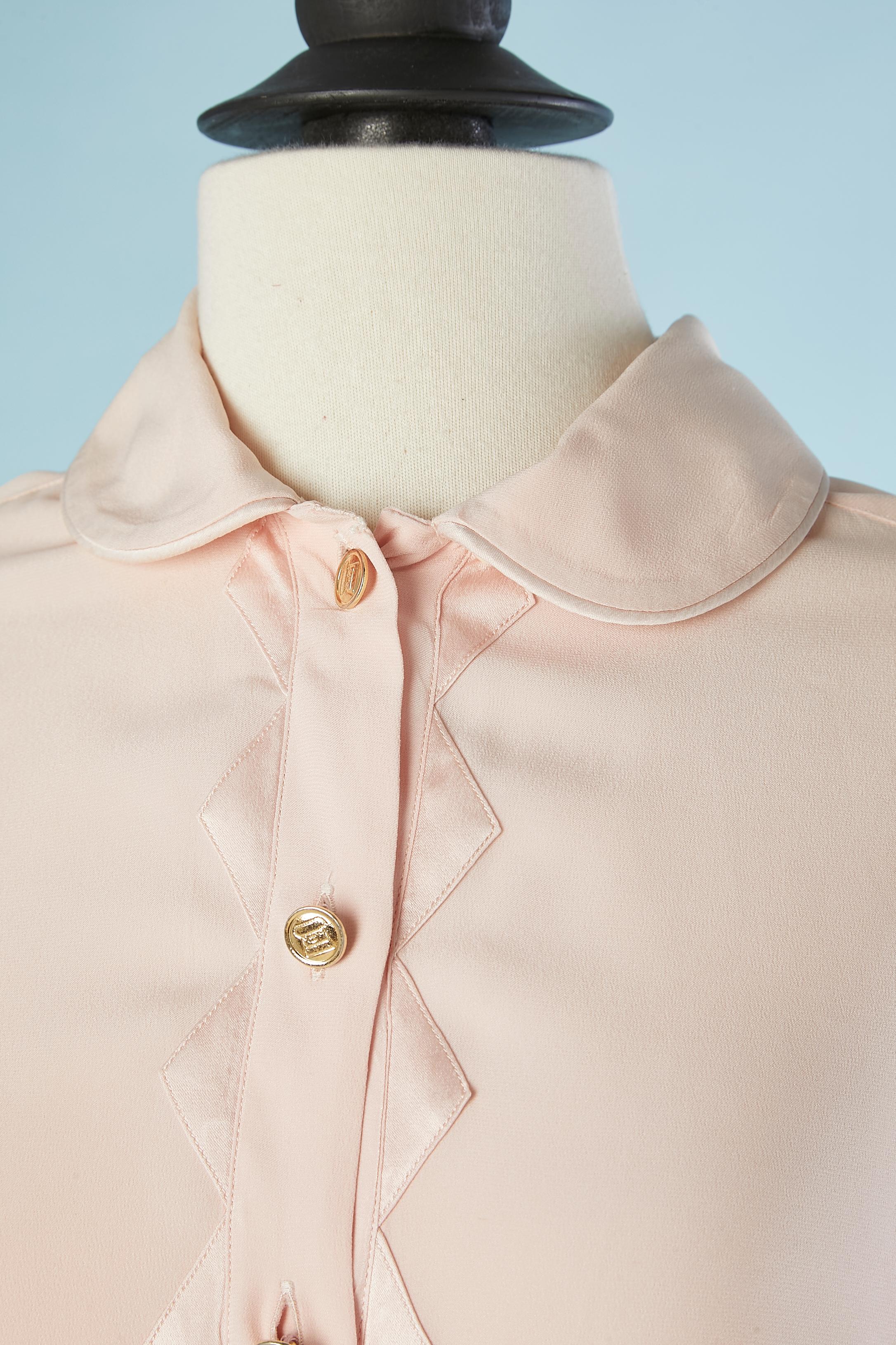 Pale pink silk shirt with silk appliqué on the button tab and cuff . Gold metal branded button. 