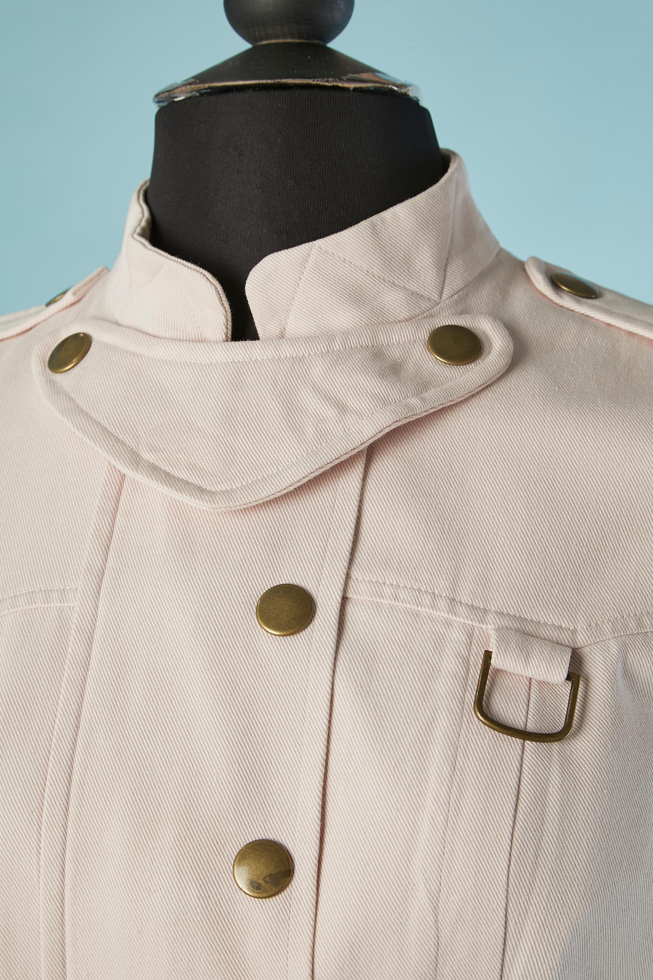 Pale pink sleeveless cotton dress with snap closure on the middle front with zip closure underneath. Lining in the same fabric ( only inside the top of the dress) Belt in the same fabric.
Pocket on both side 