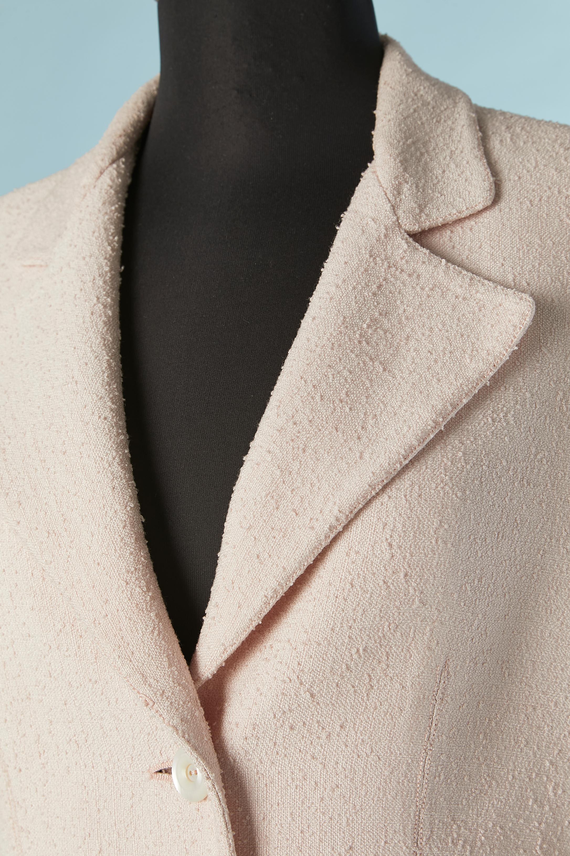 Pale pink tweed skirt suit. Main fabric composition: 100% rayon. Lining: 100% polyester. 
Raglan sleeve. Box pleats on the jacket. Split on the side front of the skirt. 
size 12 (Us) L 