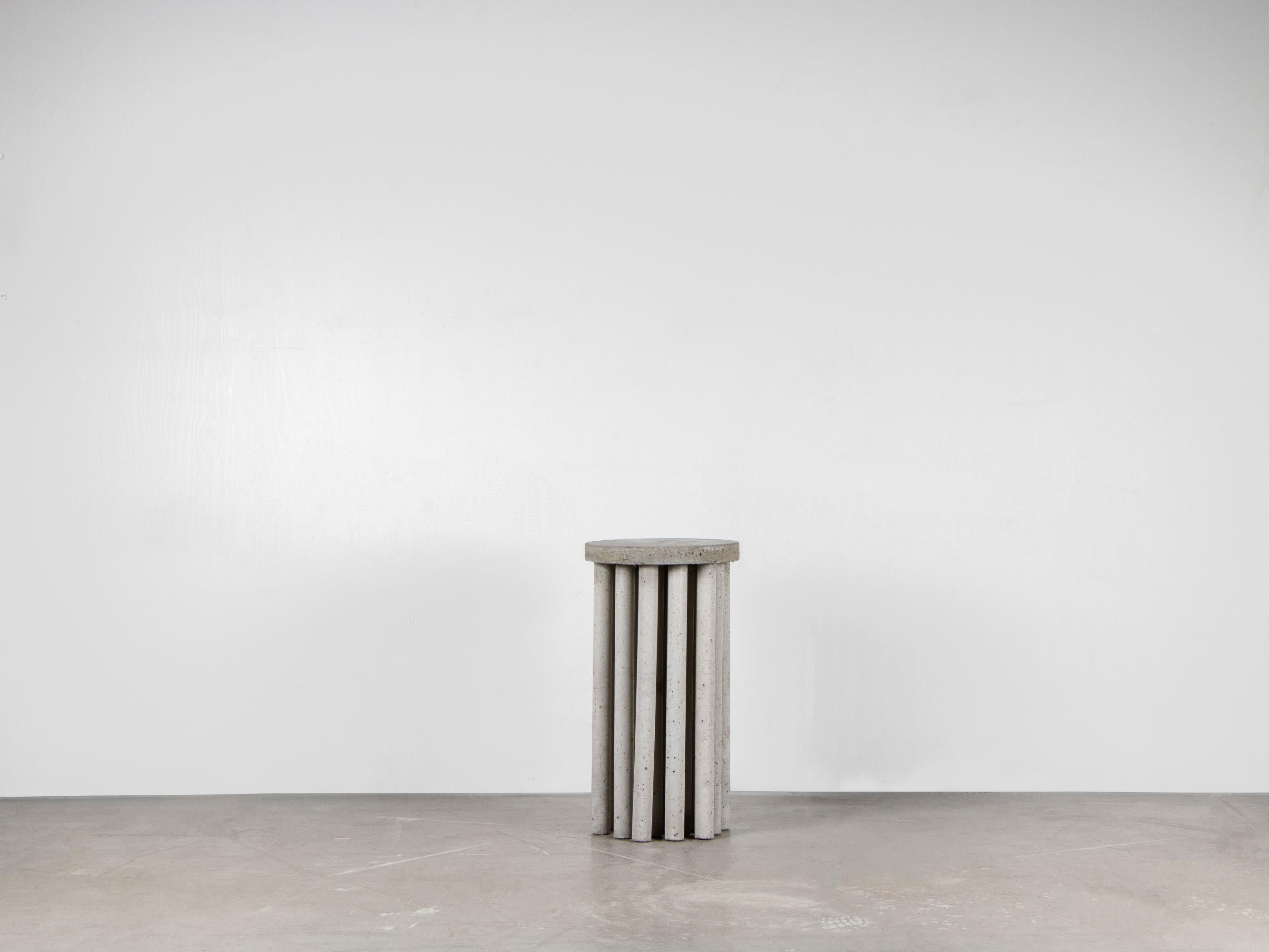 PÅLE Sculpted side table by Lucas Tyra Morten
2018
Limited edition of 23
Dimensions: Ø 30, H 56 cm
Material: Sculpted in raw concrete

With elements fetched by the architectural era brutalism combined with a figurative memory of a group of