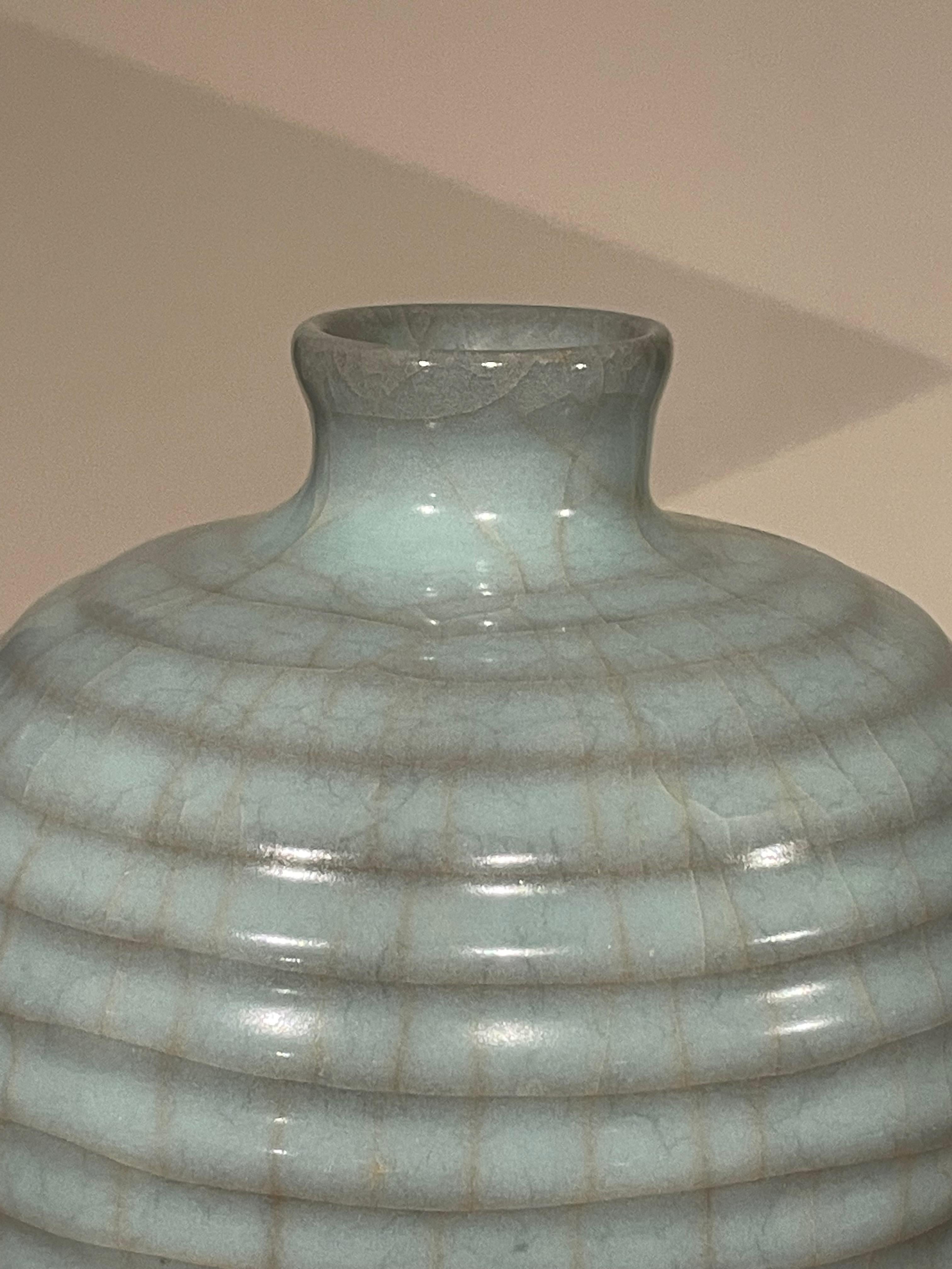 Contemporary Chinese pale turquoise vase.
Horizontal rib design.
Large collection available with varying sizes and shapes.
