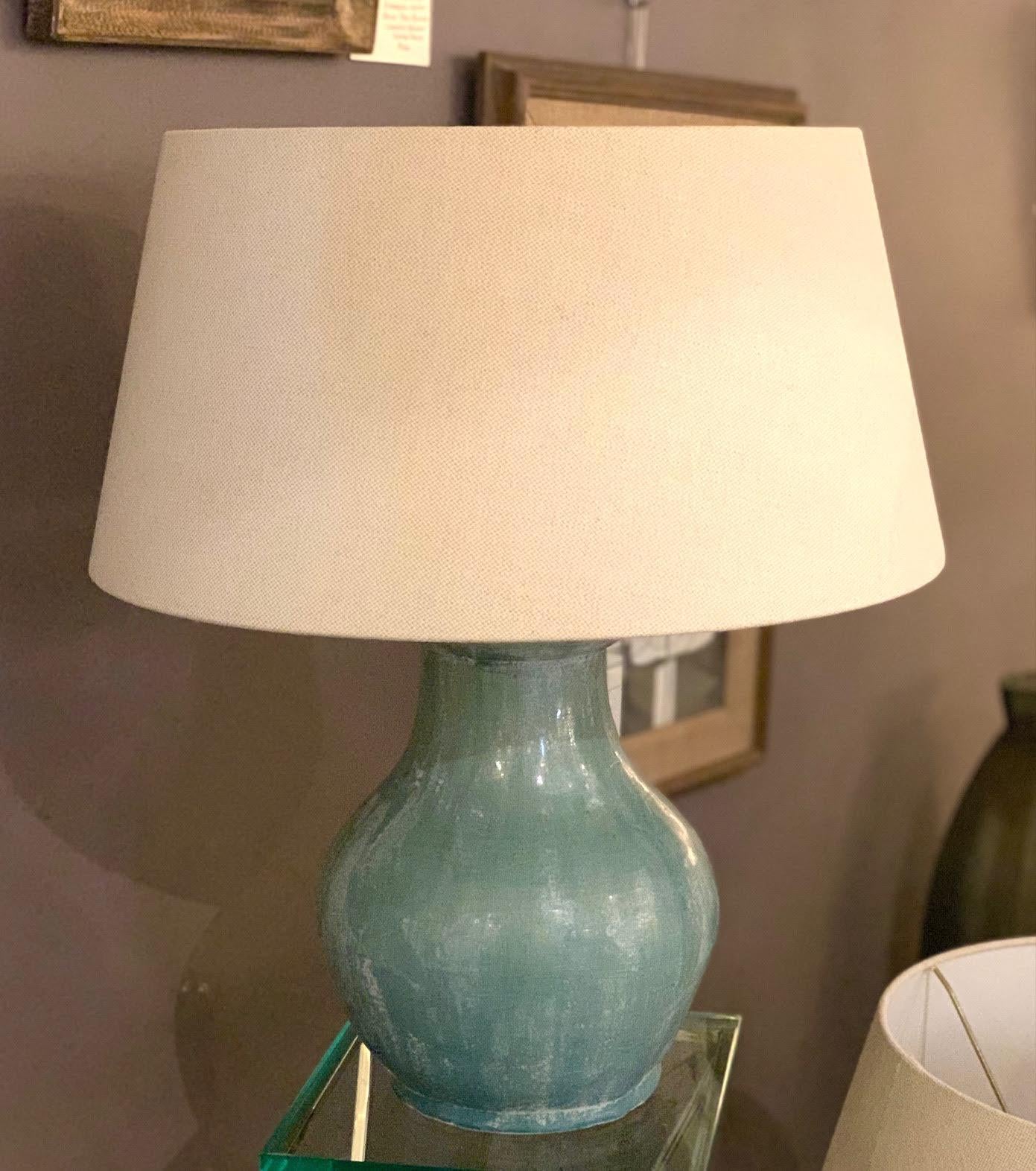 Contemporary Chinese pair of weathered light turquoise colored glazed lamps.
Base measures 9D x 11H
Belgian linen shades
Shade diamter 17.5